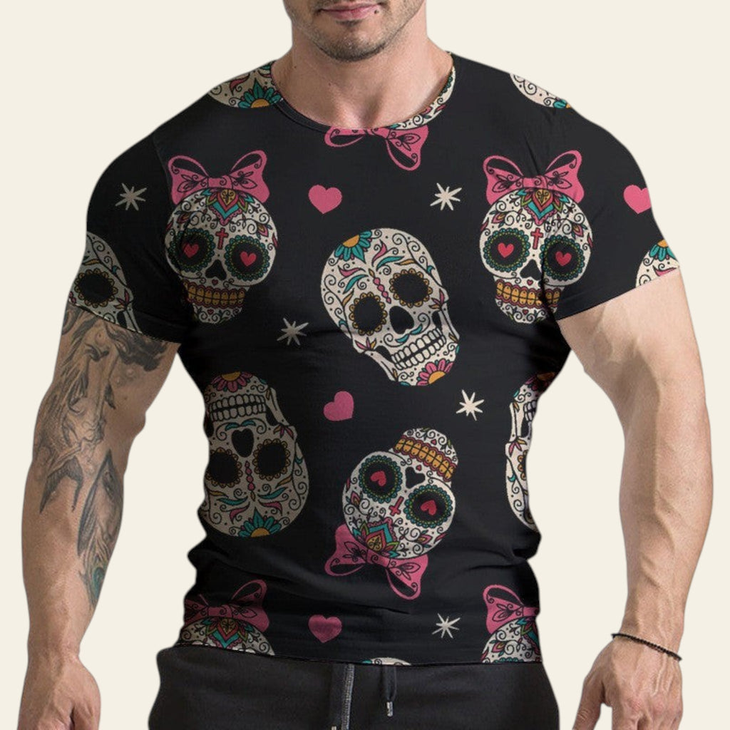 Black t-shirt with colorful skull designs and pink bows worn by a person.