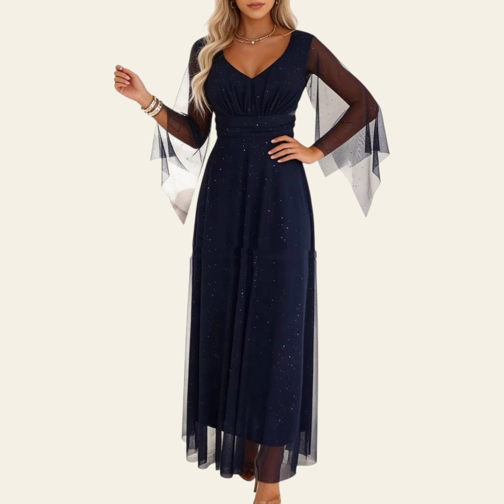 Woman wearing a navy blue long mesh dress with sheer sleeves