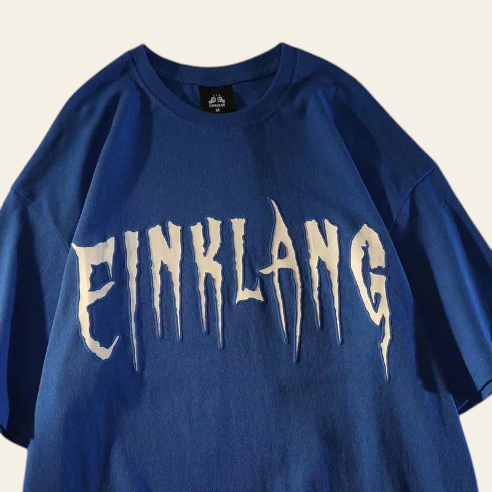 Blue sweatshirt with 'PINKLANG' text on a newspaper background