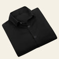 Folded black shirt on a white background