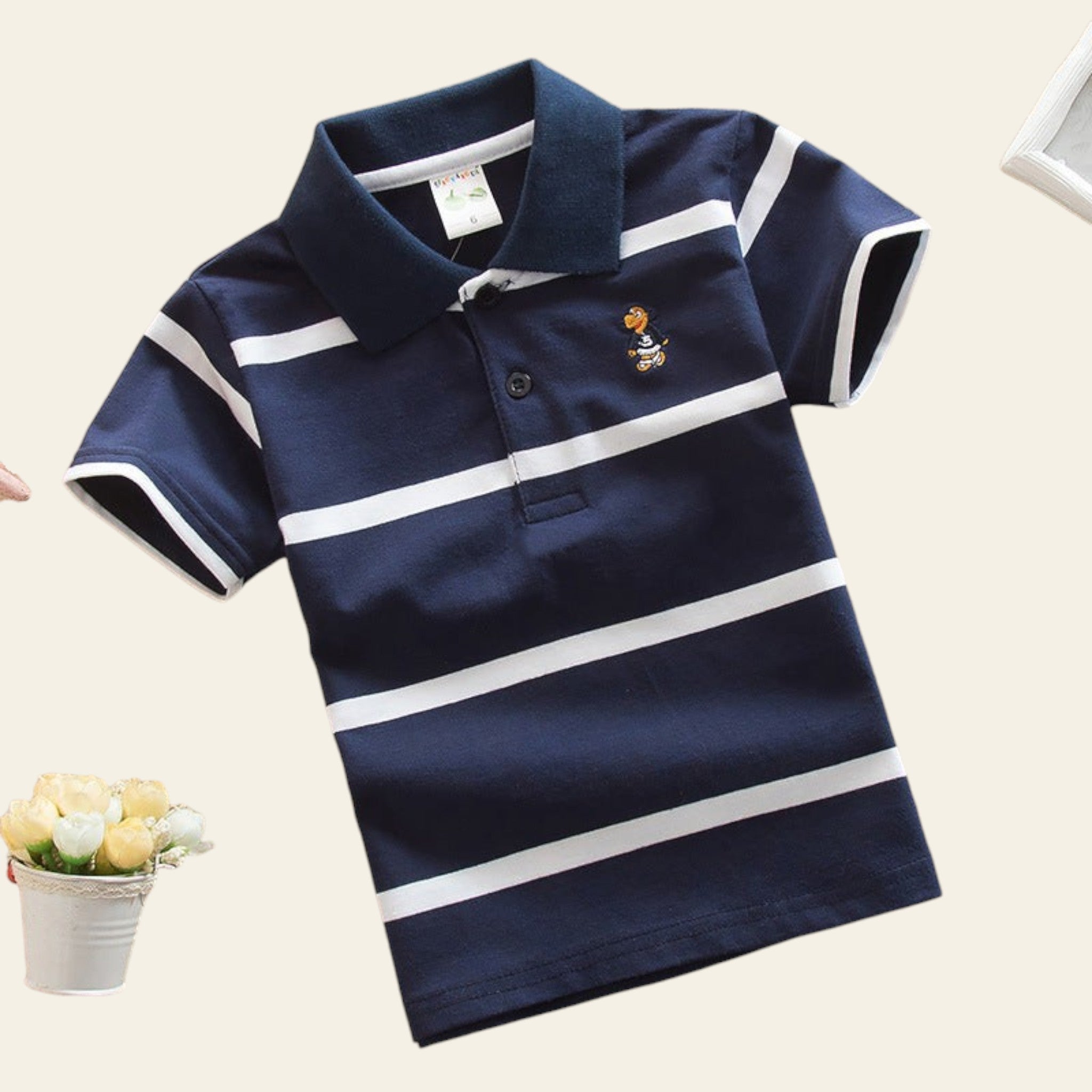 Navy blue polo shirt with white stripes on a beige surface