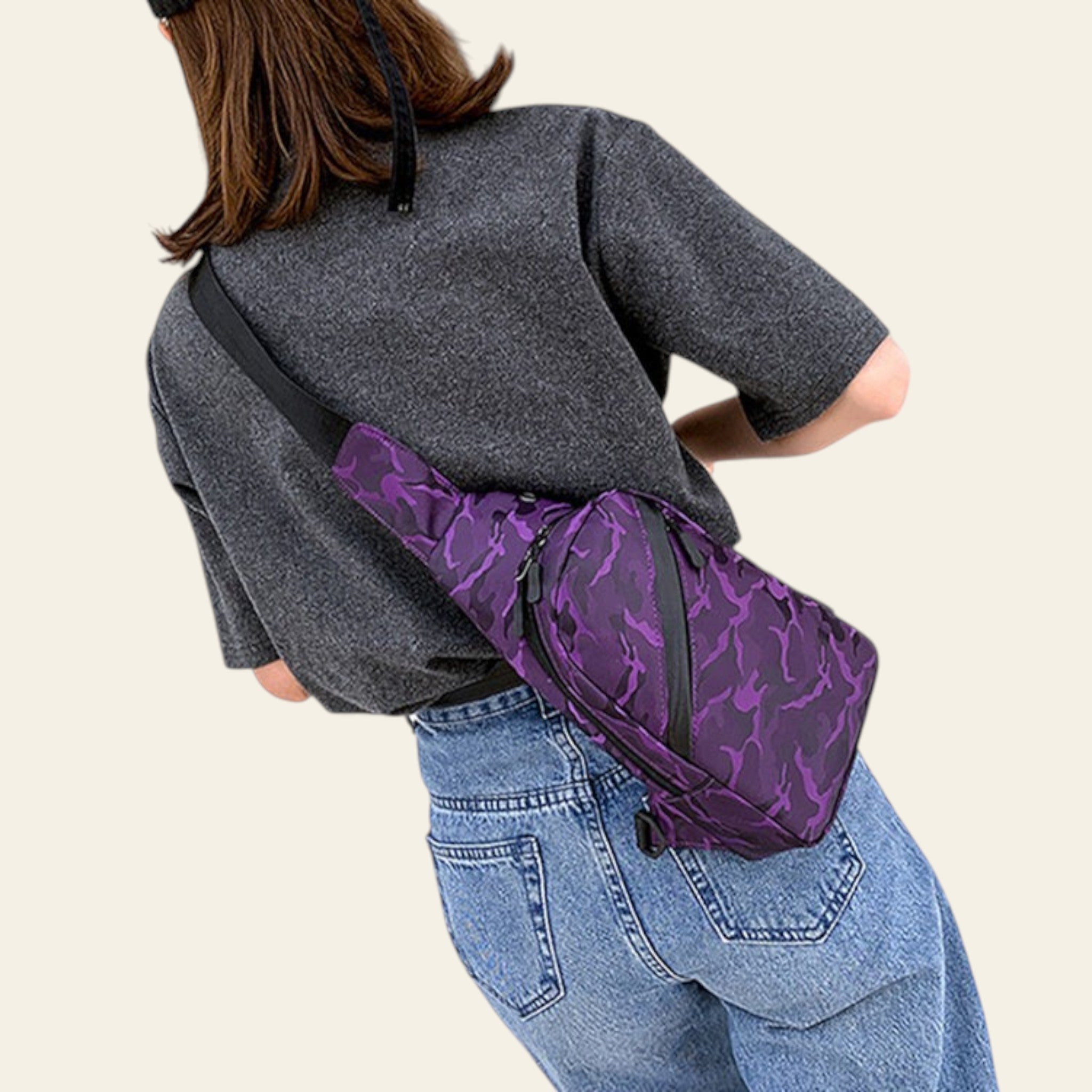 Person wearing a purple camouflage-patterned bag over one shoulder, standing on a wooden floor.