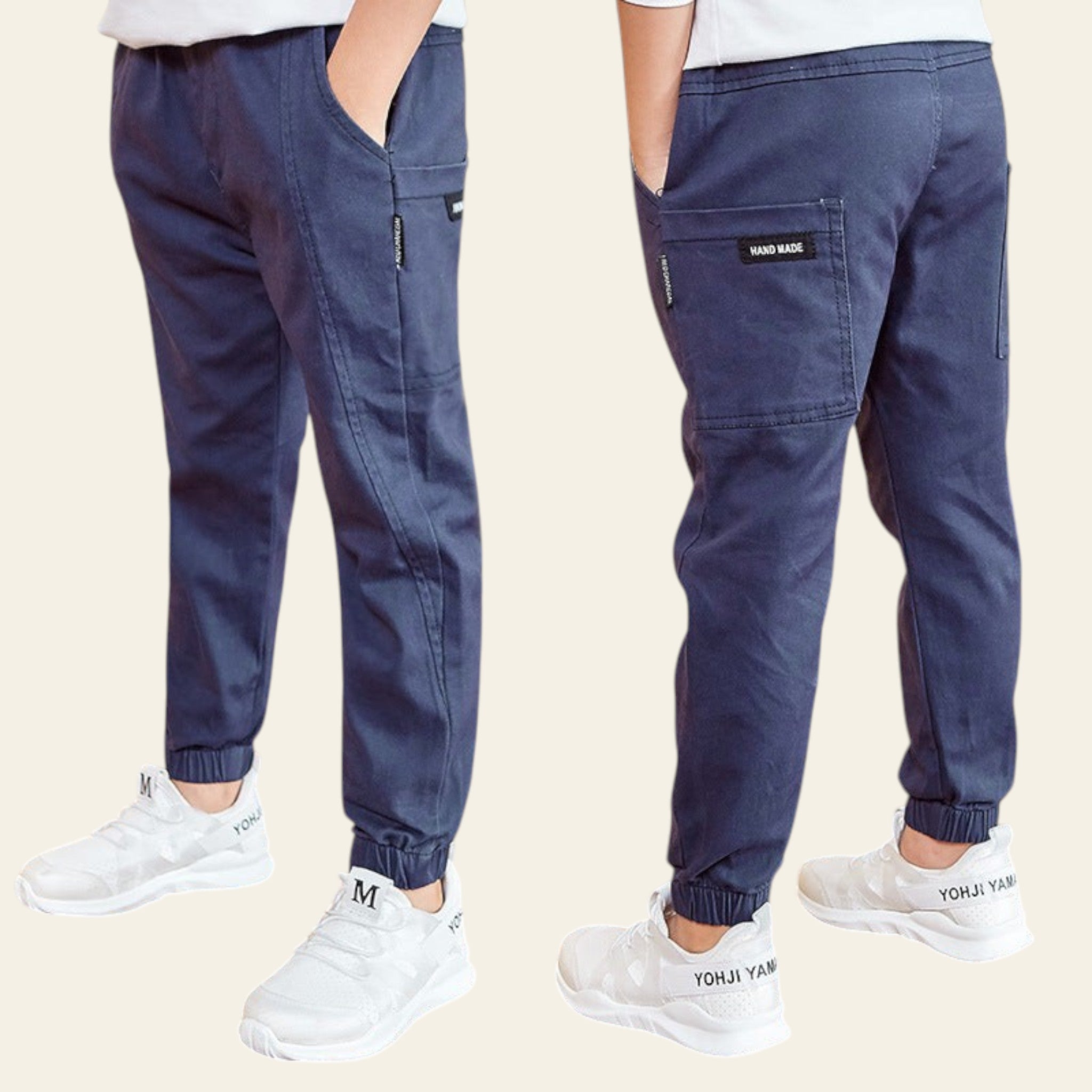 Navy jogger pants worn by a person on a wooden floor with a Starbucks sign in the background.