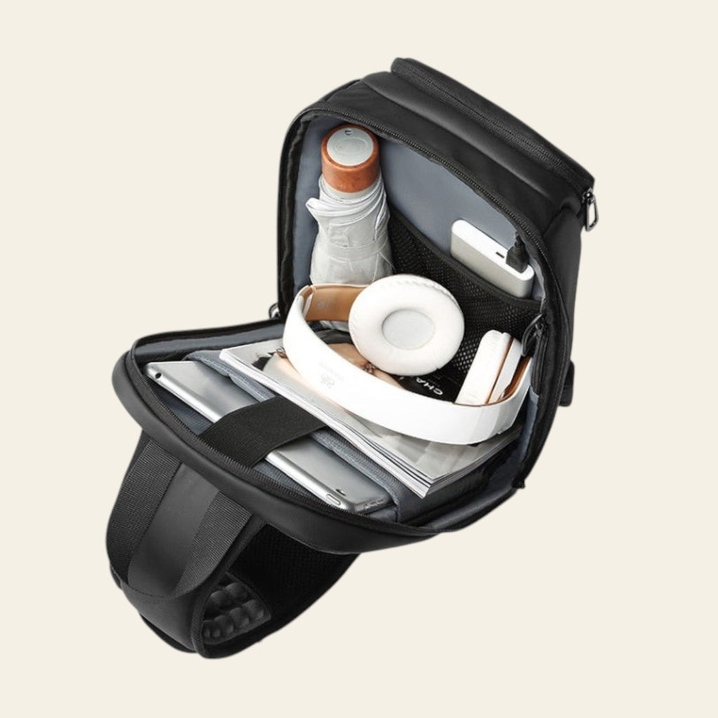 Black backpack with organized compartments on a white background