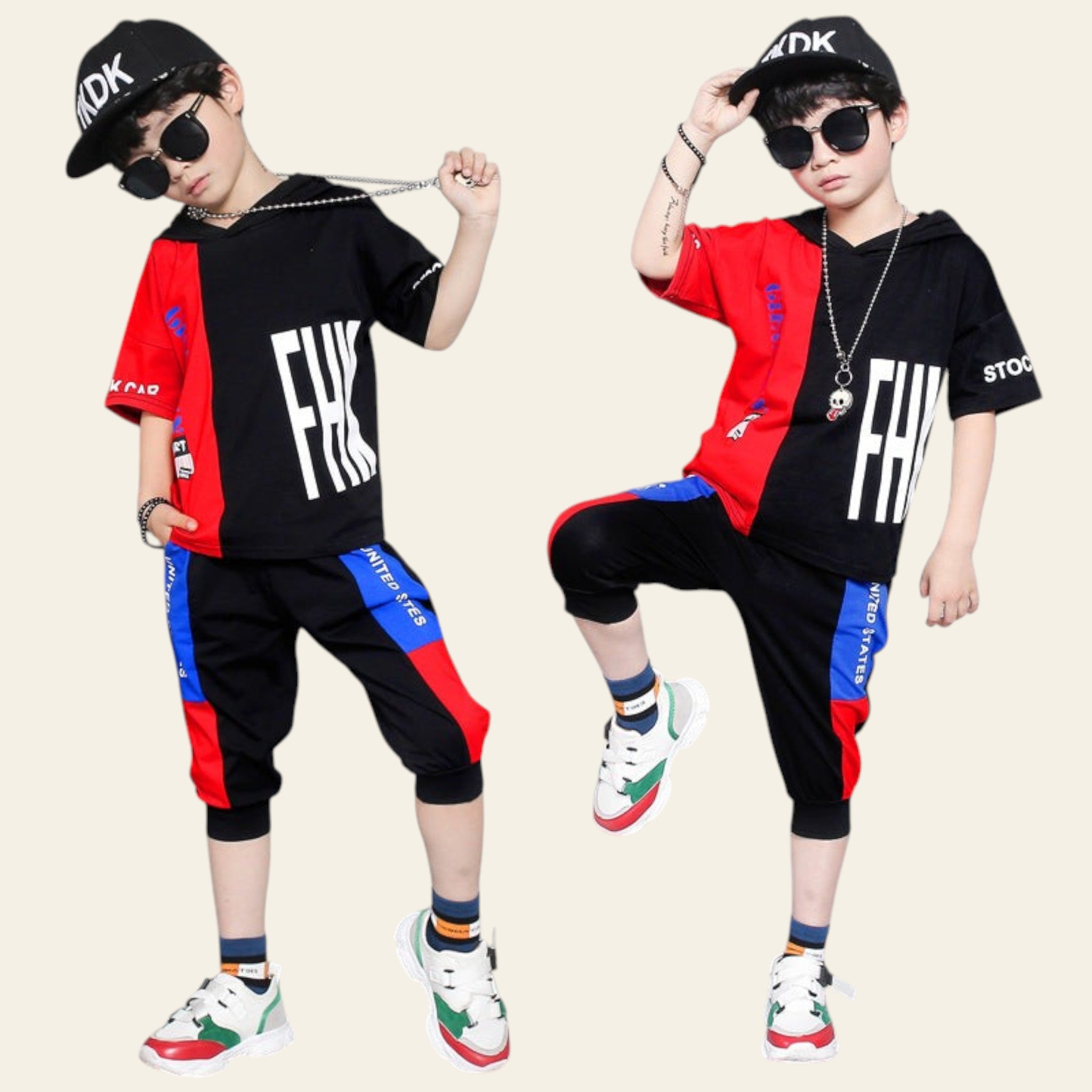 Two children wearing matching black and red outfits with colorful accents on a gray background.