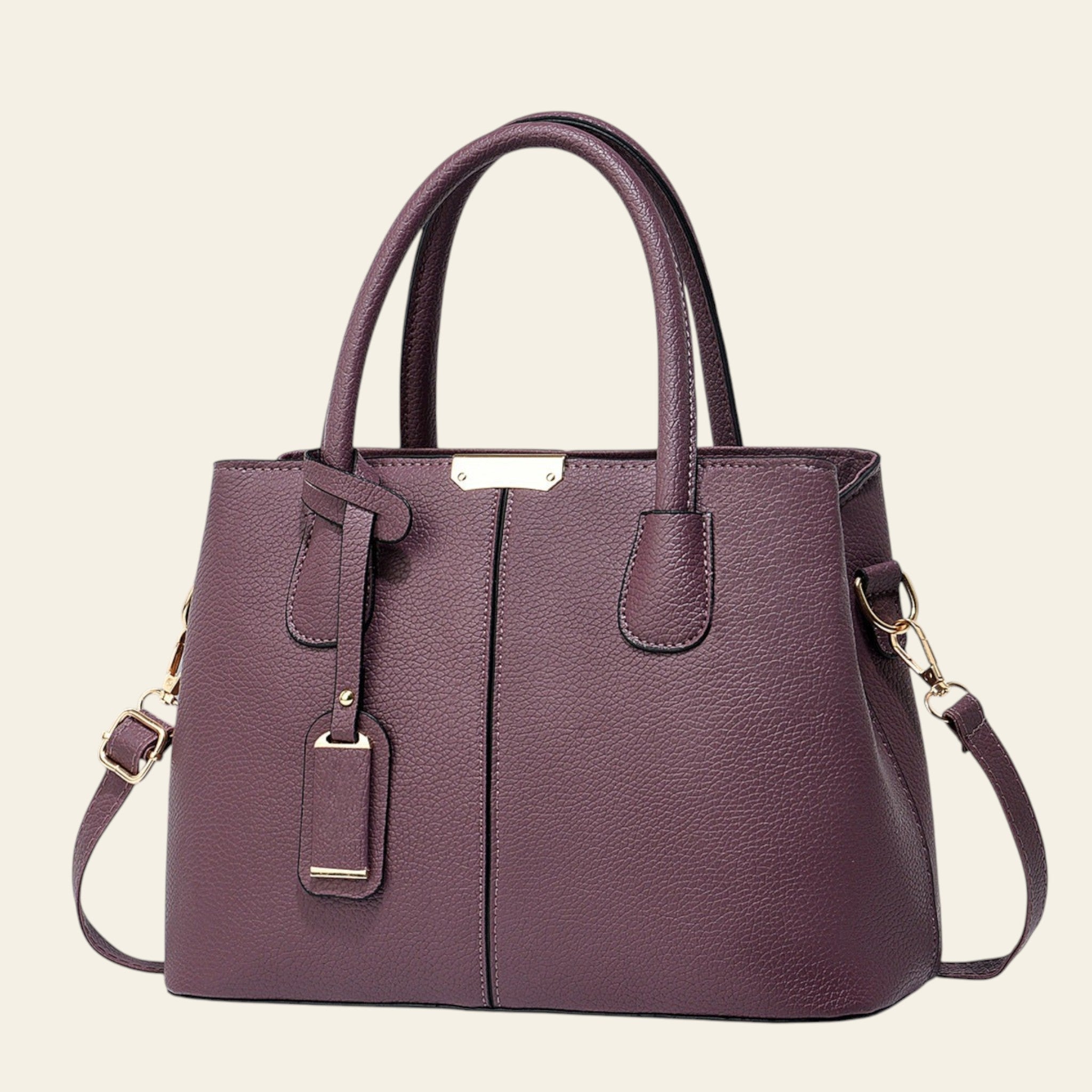 Purple handbag with gold accents on a white background