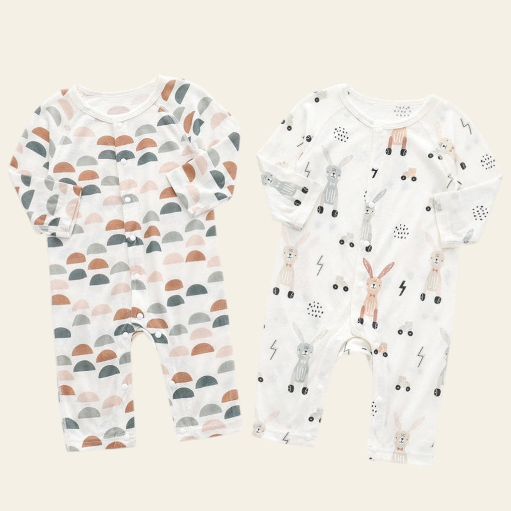 Two baby rompers with different patterns on a white background