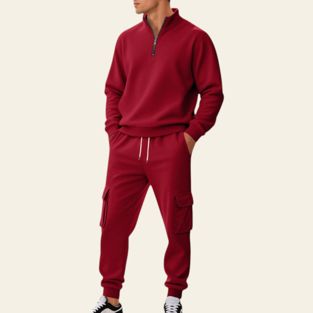 Man wearing a red fleece-lined tracksuit set with zip-up jacket and jogger pants on a city