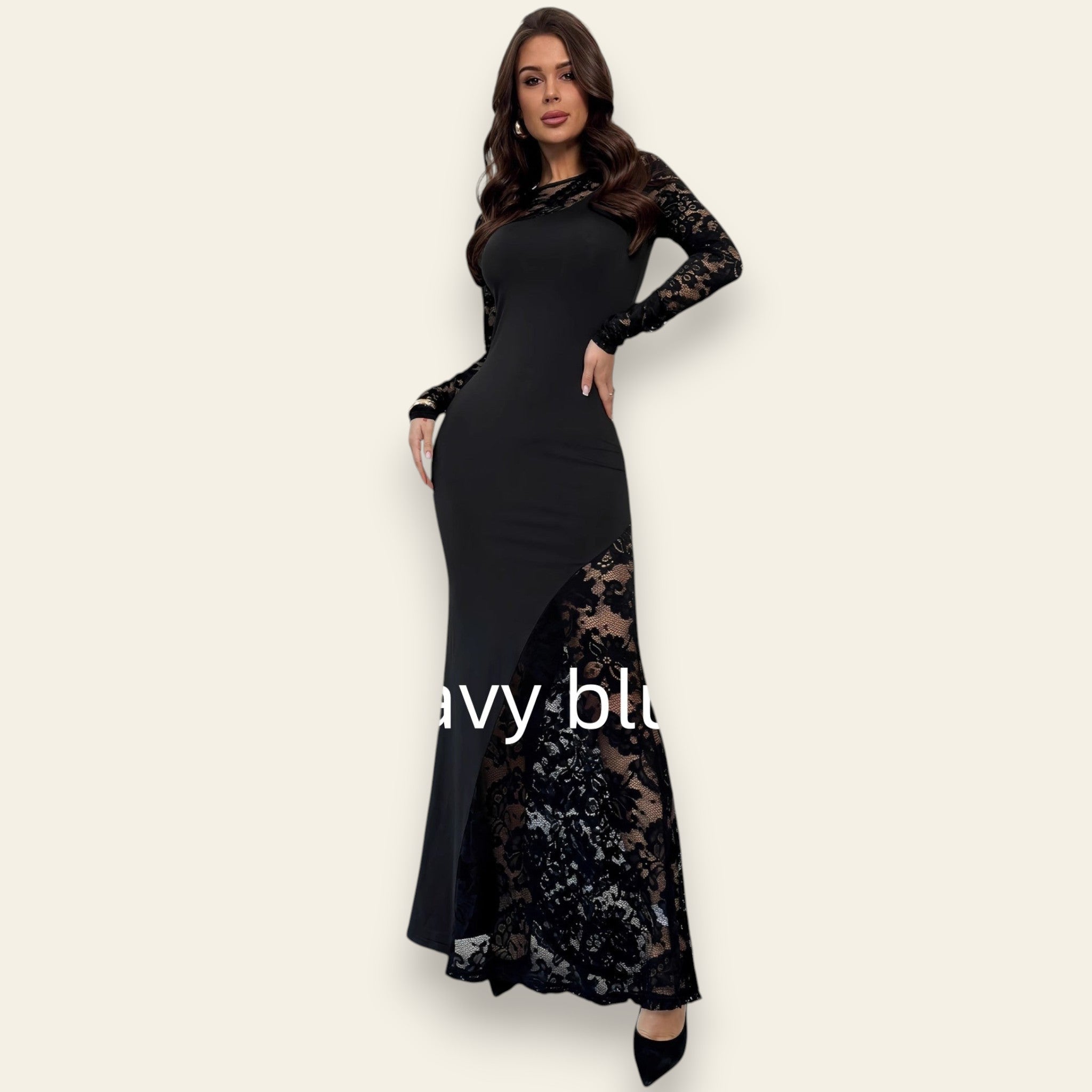 Woman wearing a navy blue lace long-sleeve bodycon maxi dress with sheer lace detailing, standing against a plain white background