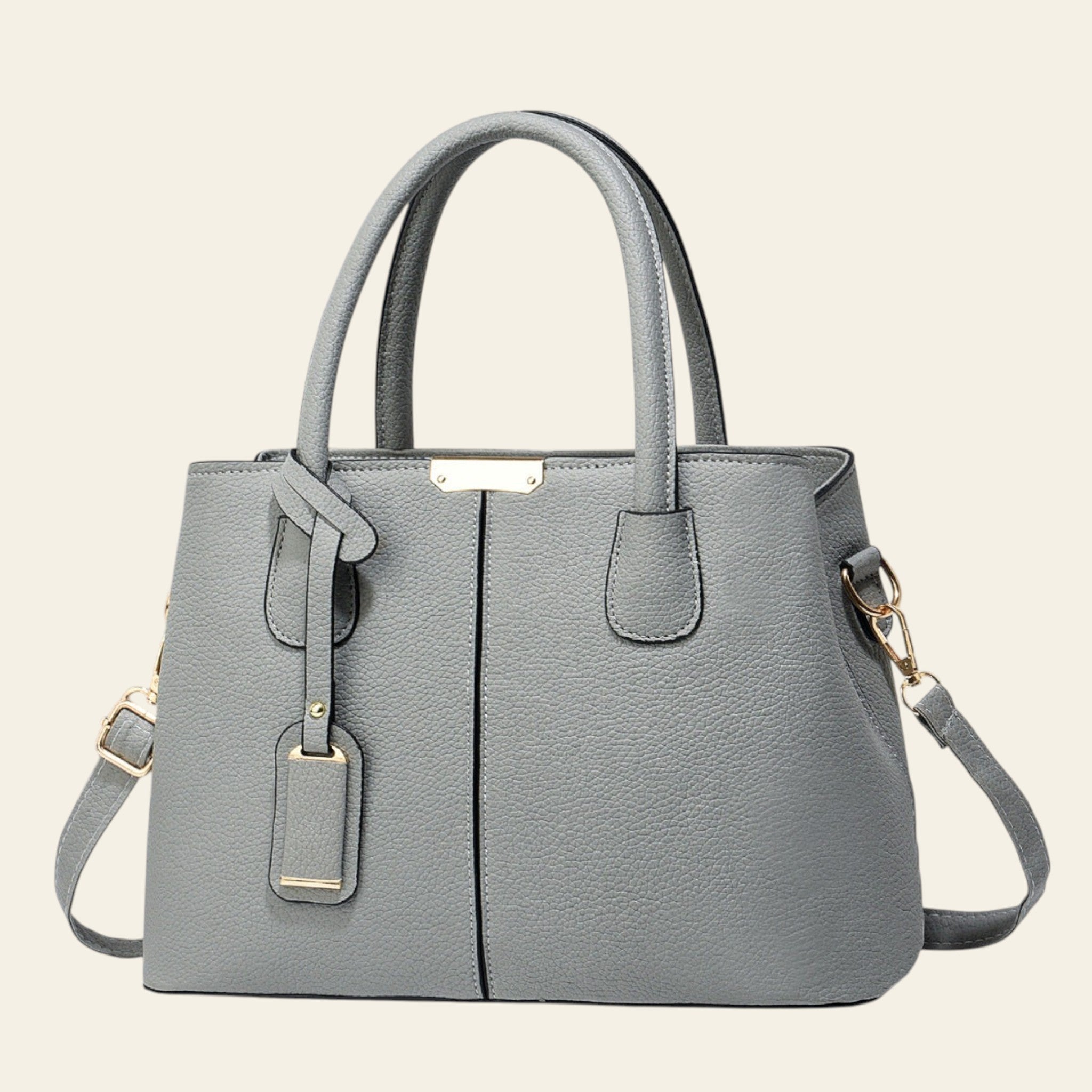 Gray handbag with gold accents on a light gray background