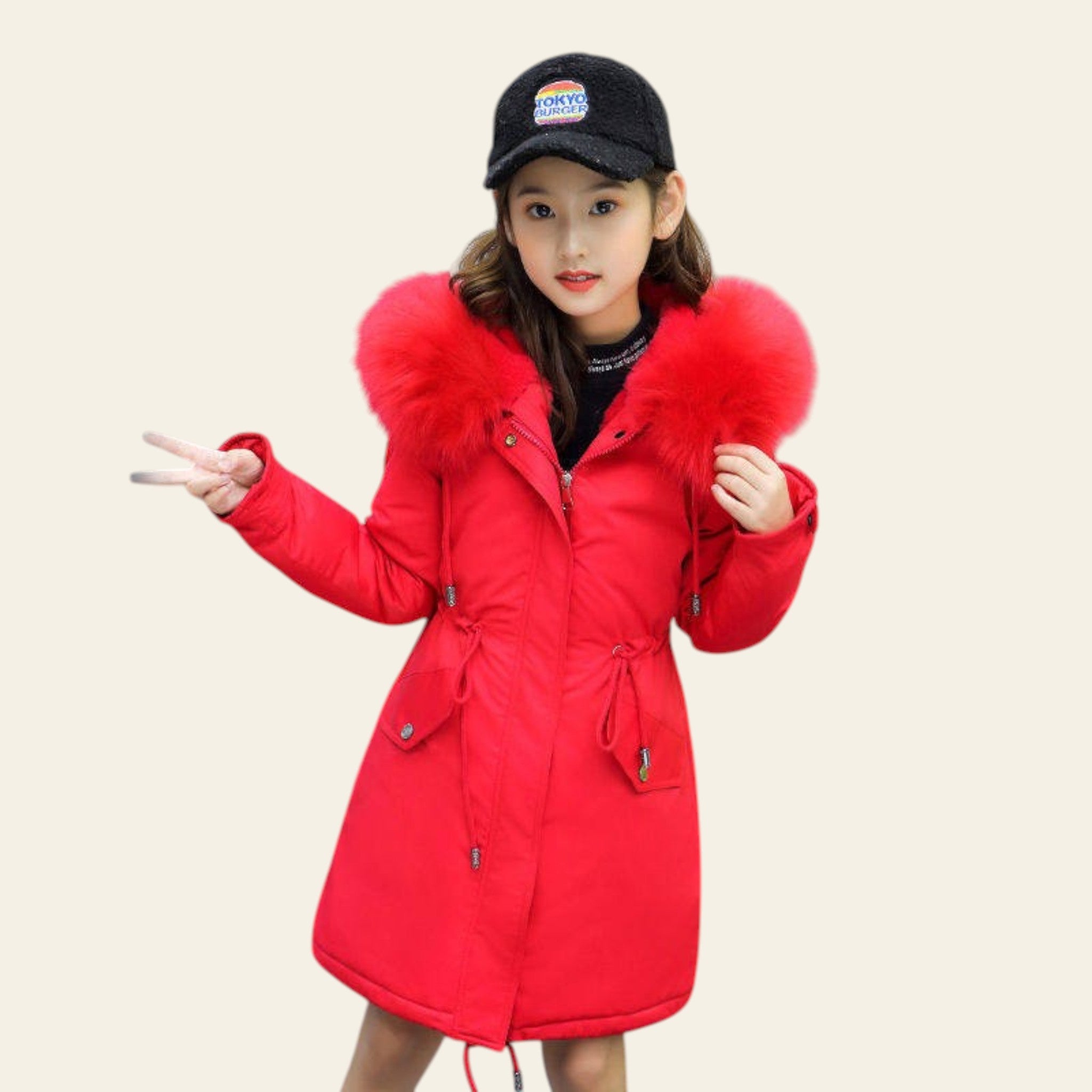 Child wearing a red coat with fur hood on a street