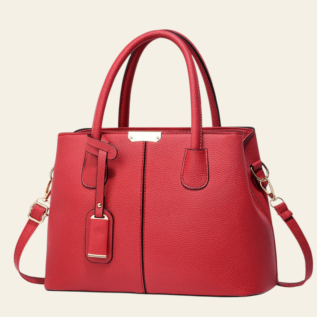 Red handbag with gold accents on a white background
