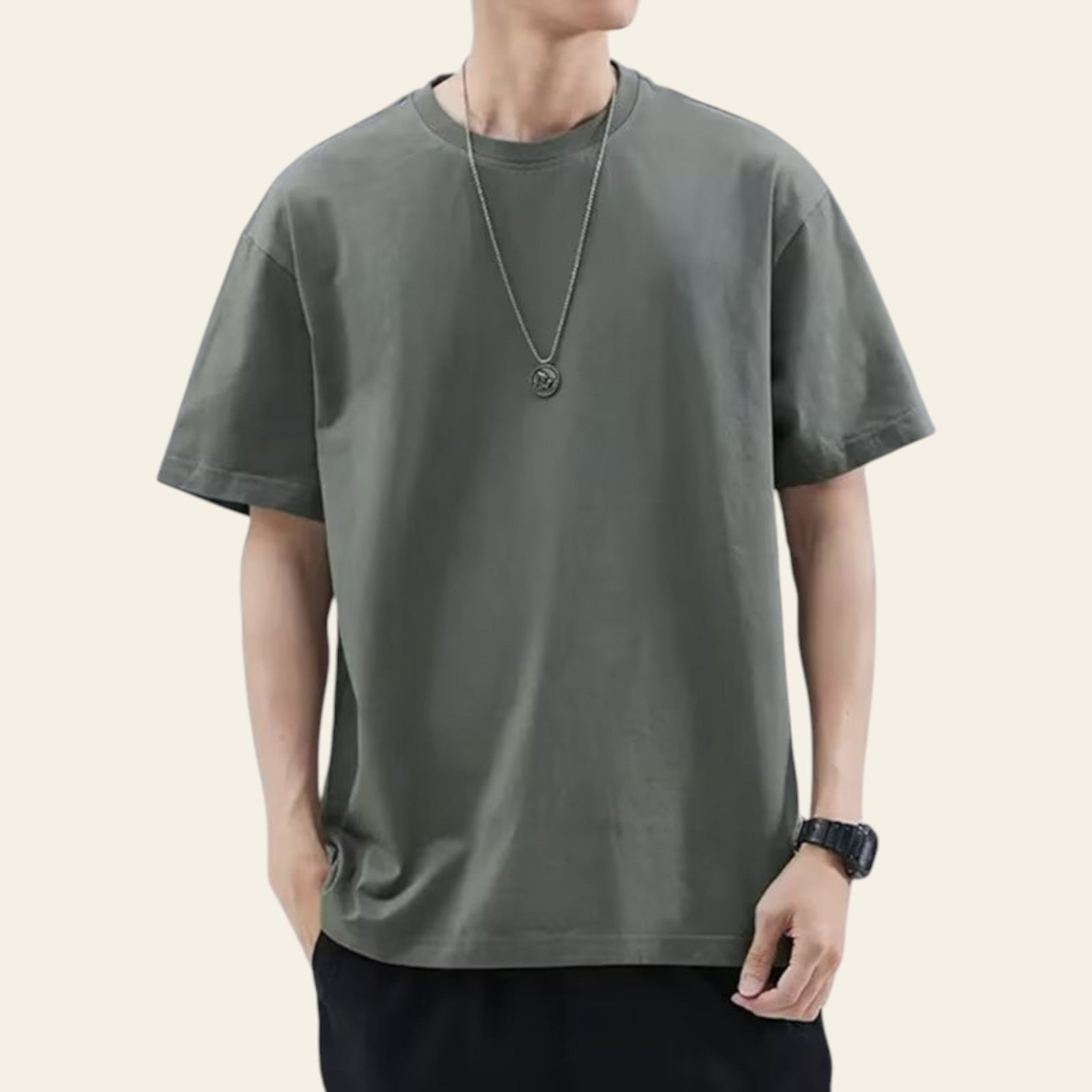 Man wearing a dark gray loose fit solid color t-shirt
