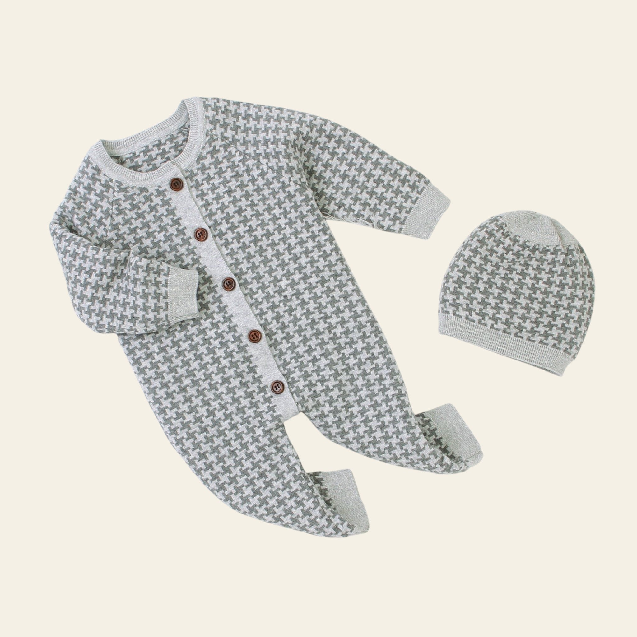 Gray patterned baby outfit with matching hat on a white background