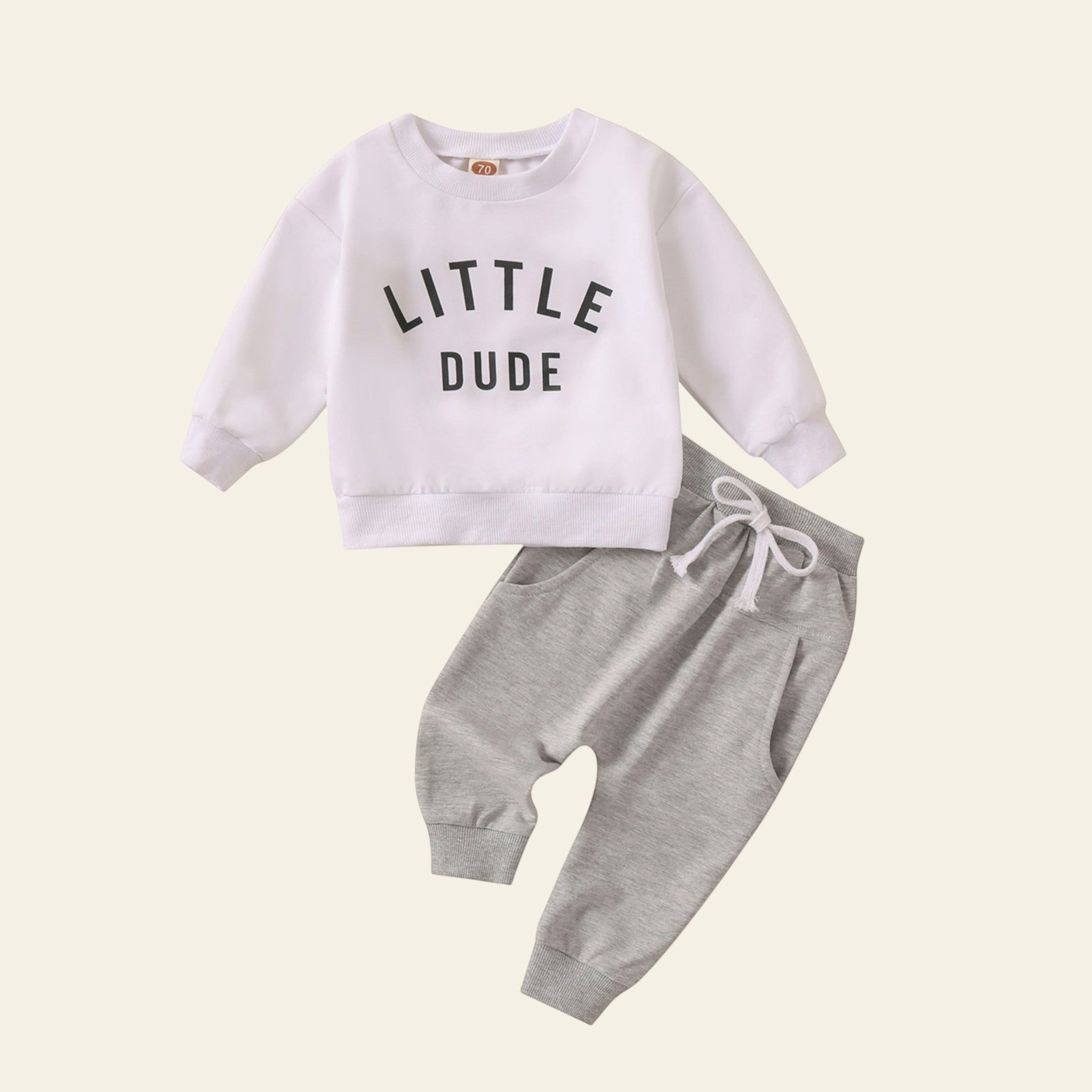 Children's outfit with white sweatshirt and gray pants on a white background