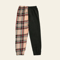 Plaid pants and black pants on a wooden surface with a magazine and toy.