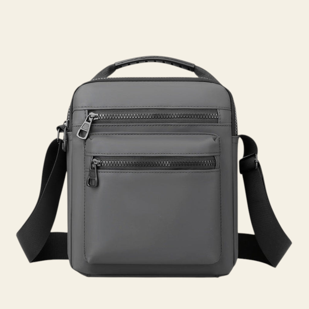 Gray backpack with multiple zippers on a white background