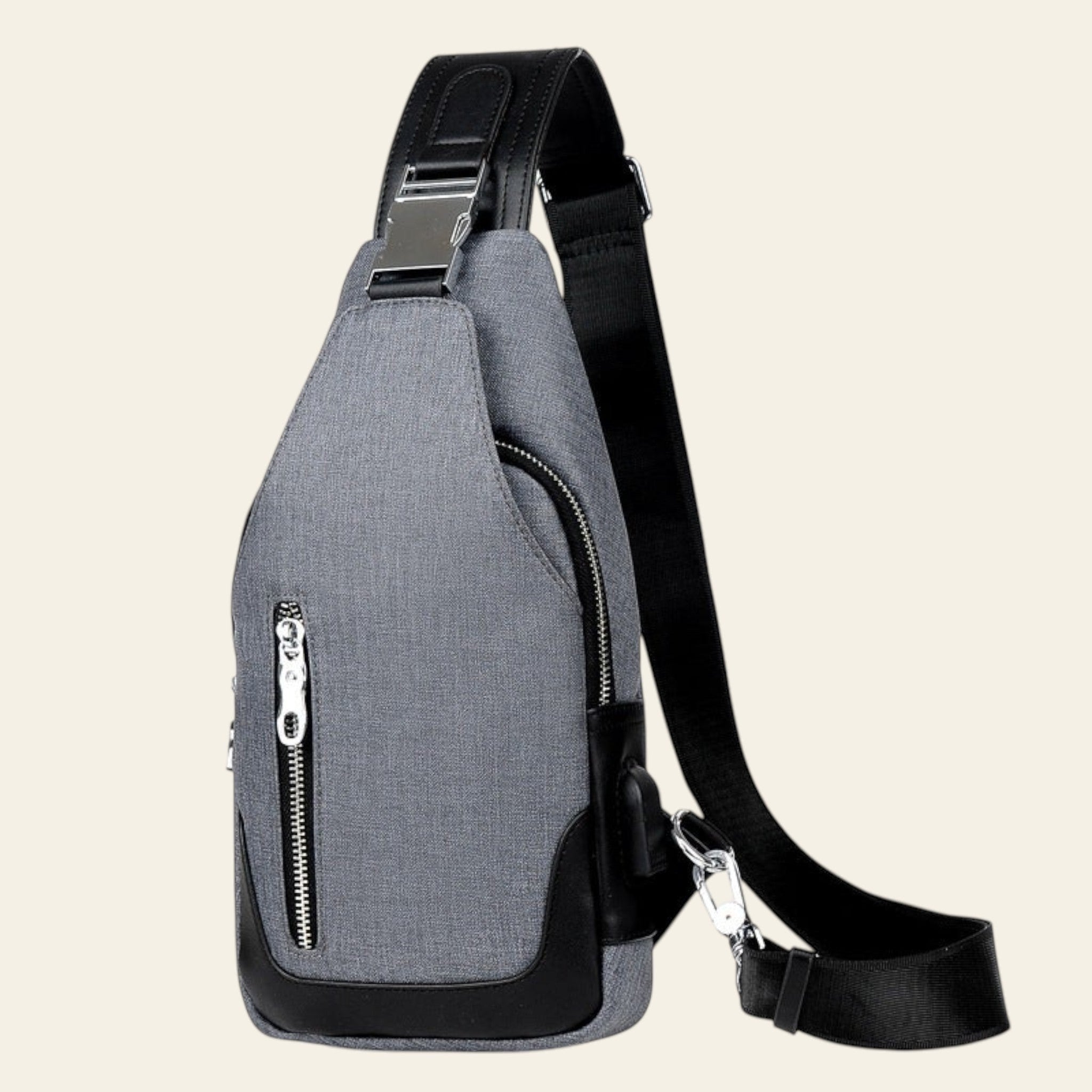 Gray sling bag with a black strap on a white background