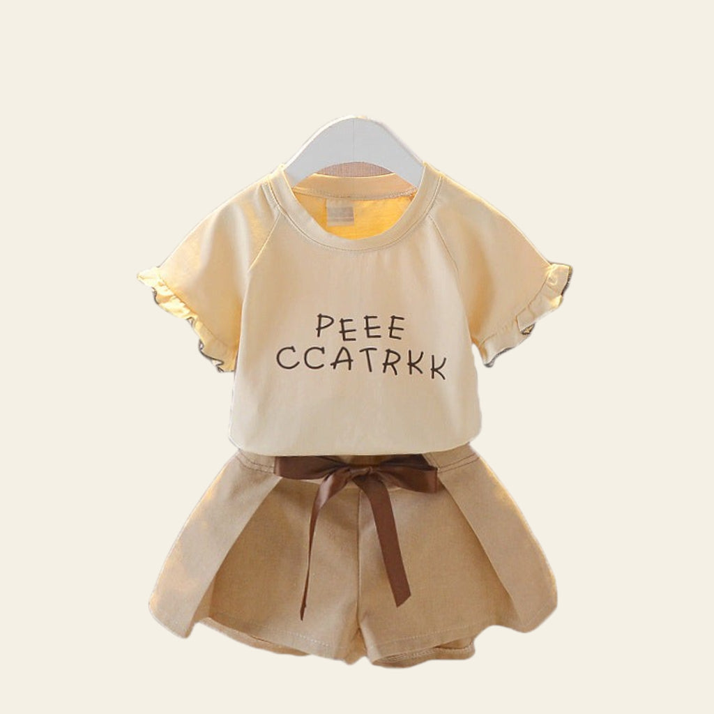 Children's outfit with a beige top and shorts on a white background