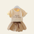 Children's outfit with a beige top and shorts on a white background