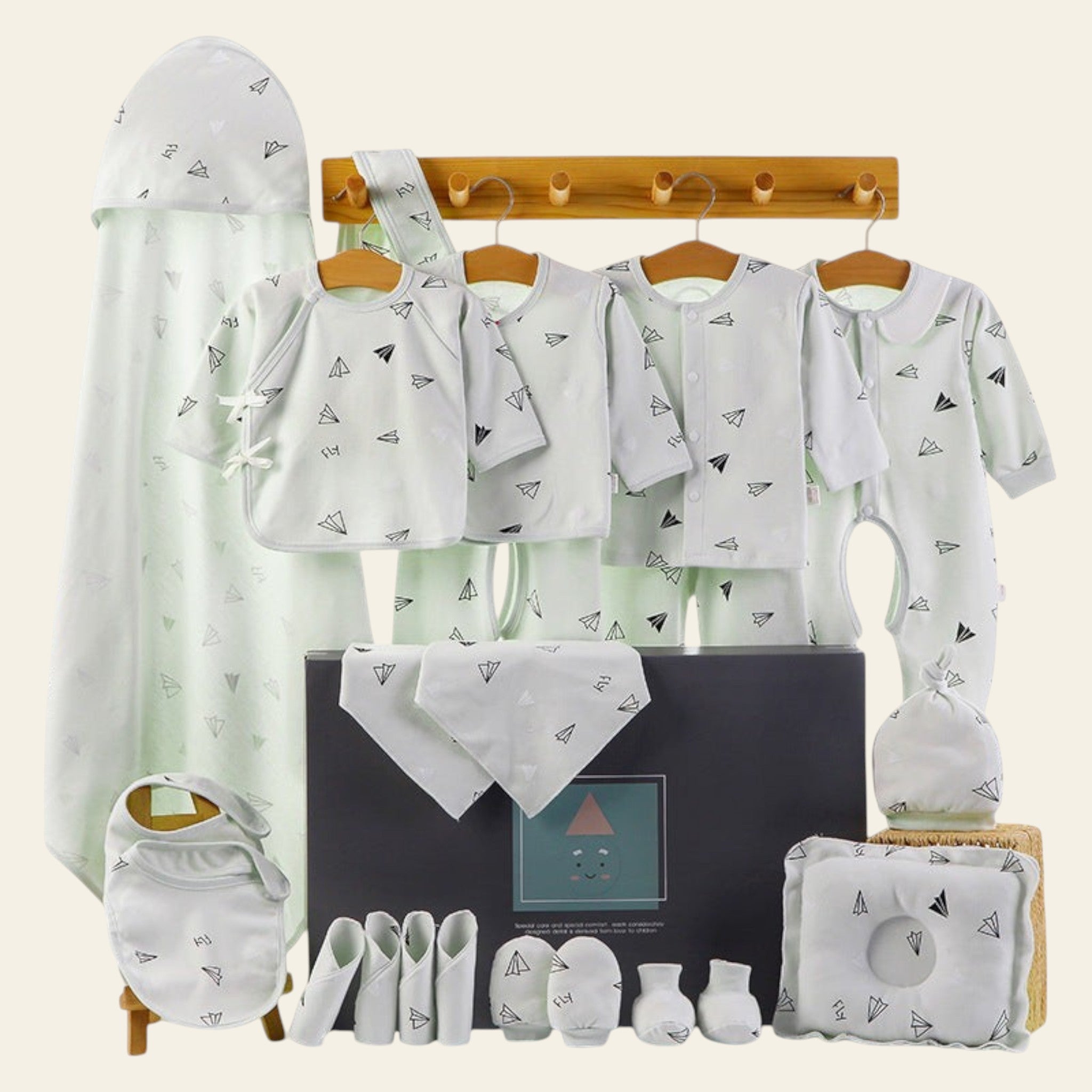 Baby clothing and accessories set with a black box on a white background