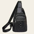 Black leather sling bag with multiple zippers on a white background