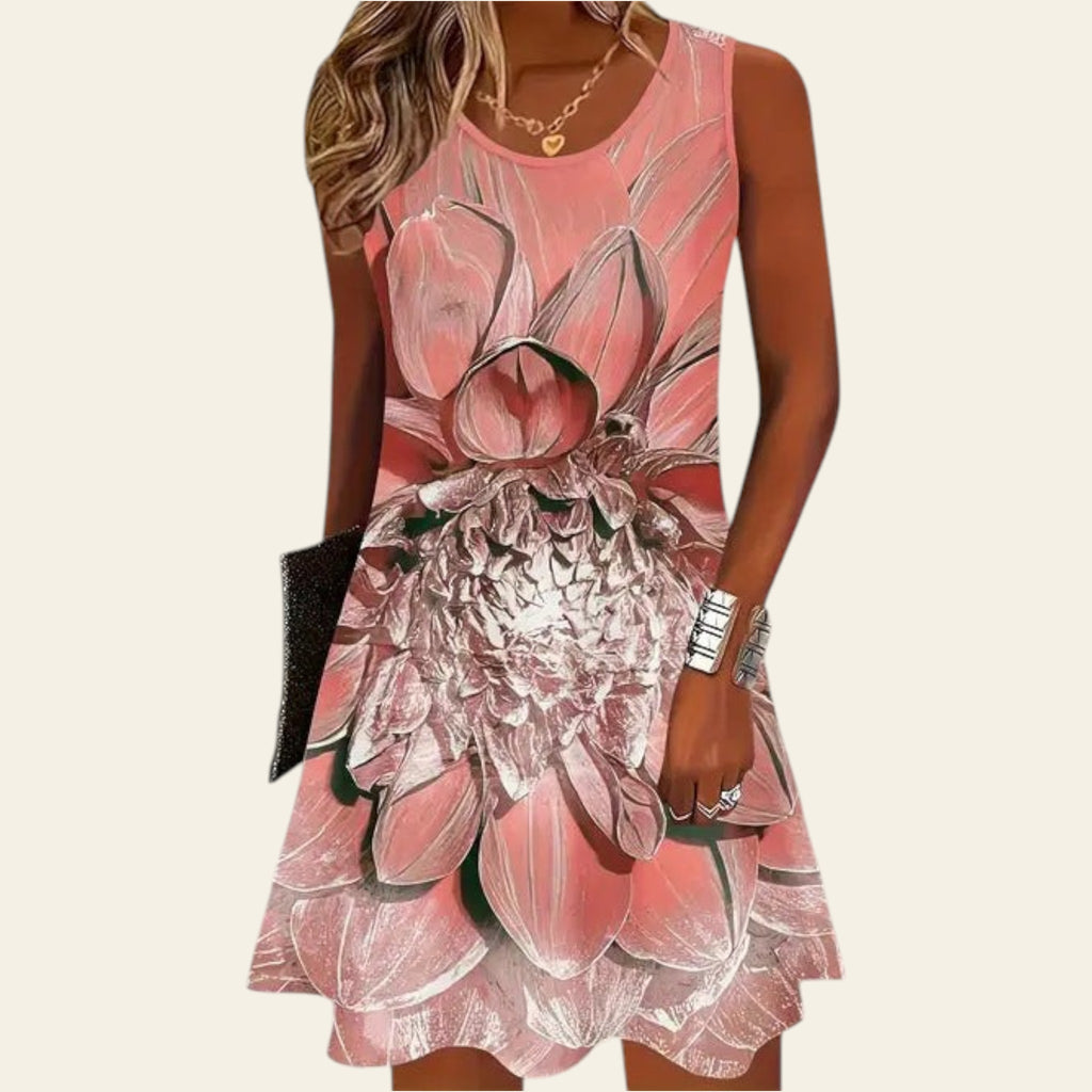 woman wearing a sleeveless pink floral dress with a soft layered flower pattern