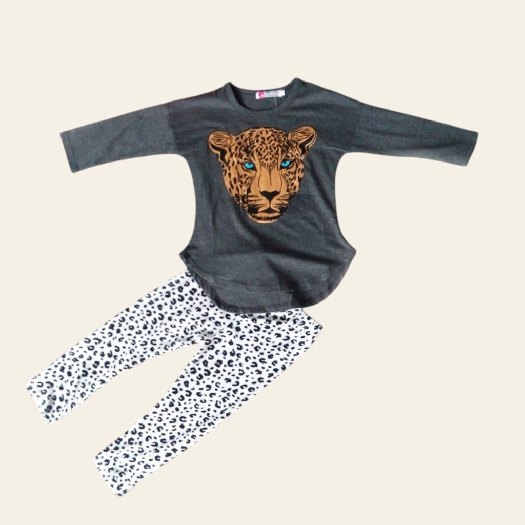 Children's outfit with gray long-sleeve top and leopard design, paired with white pants with black spots, on a light gray surface.