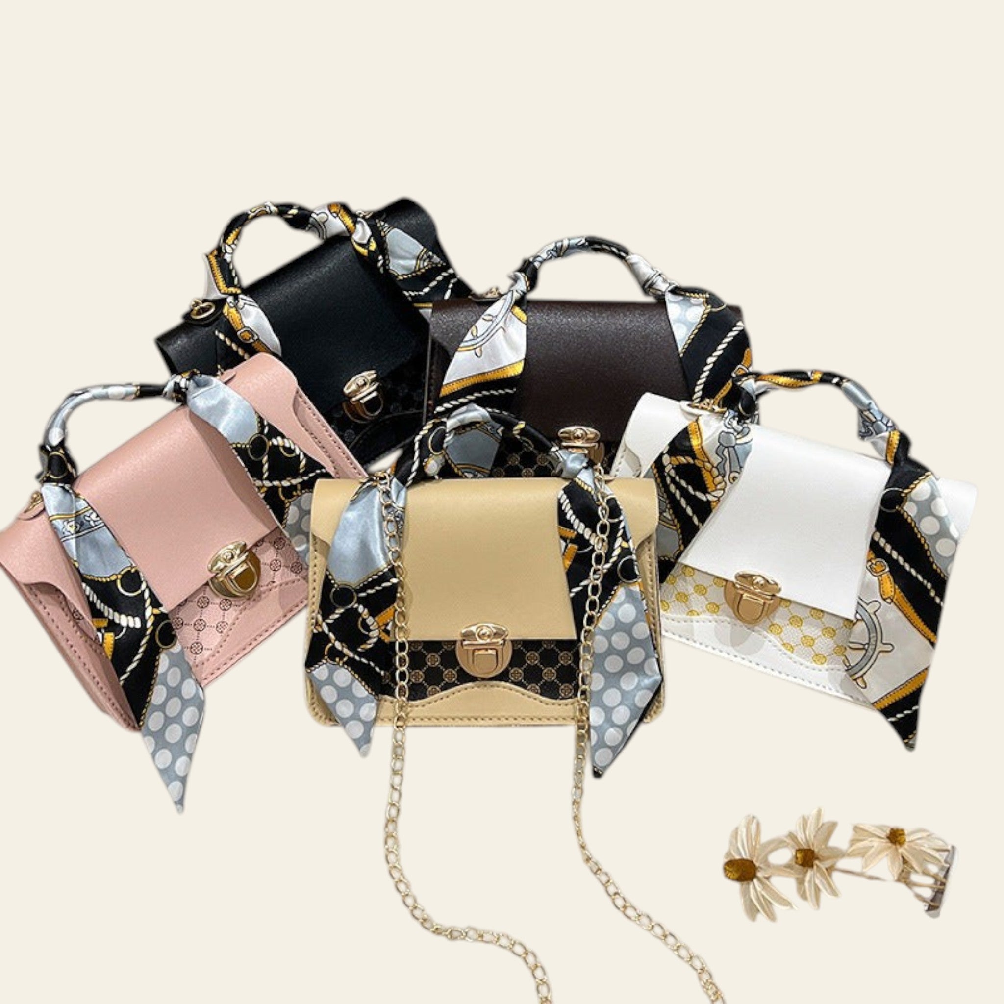 Collection of handbags with decorative straps on a fluffy white surface.