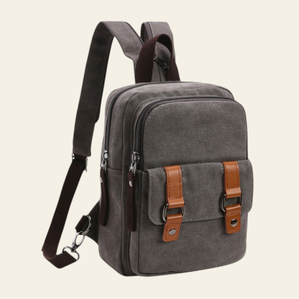 Gray backpack with brown straps and accents on a white background