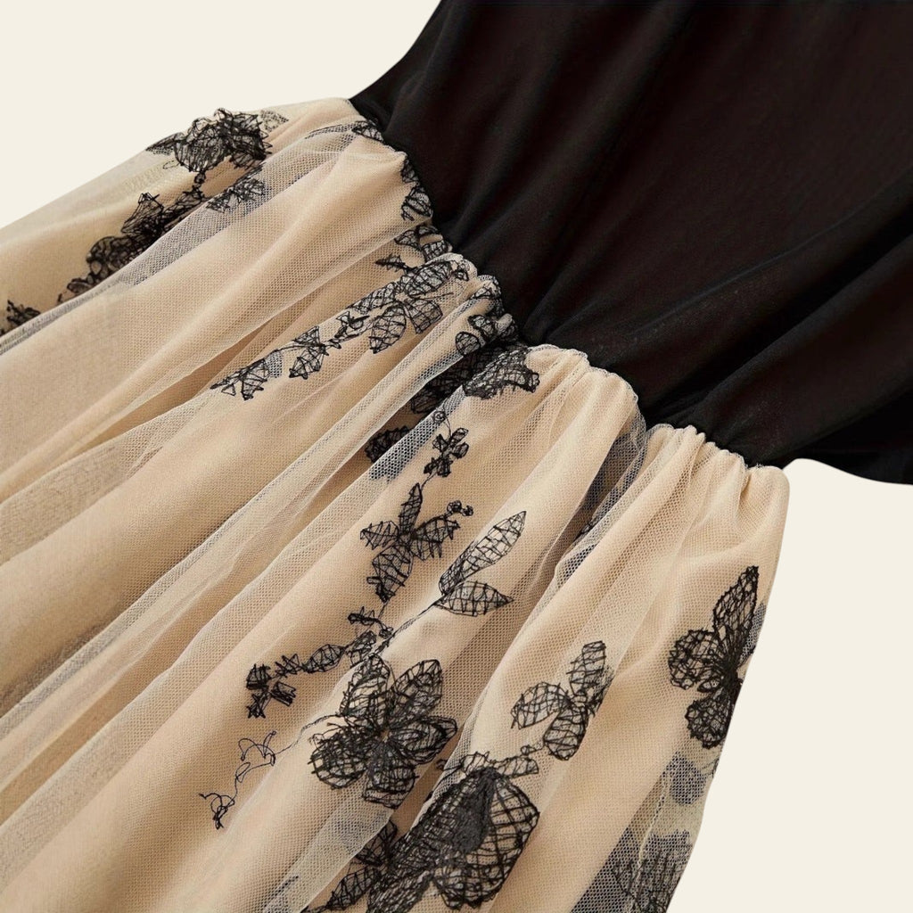 Close-up of spaghetti strap detail on black slip dress
