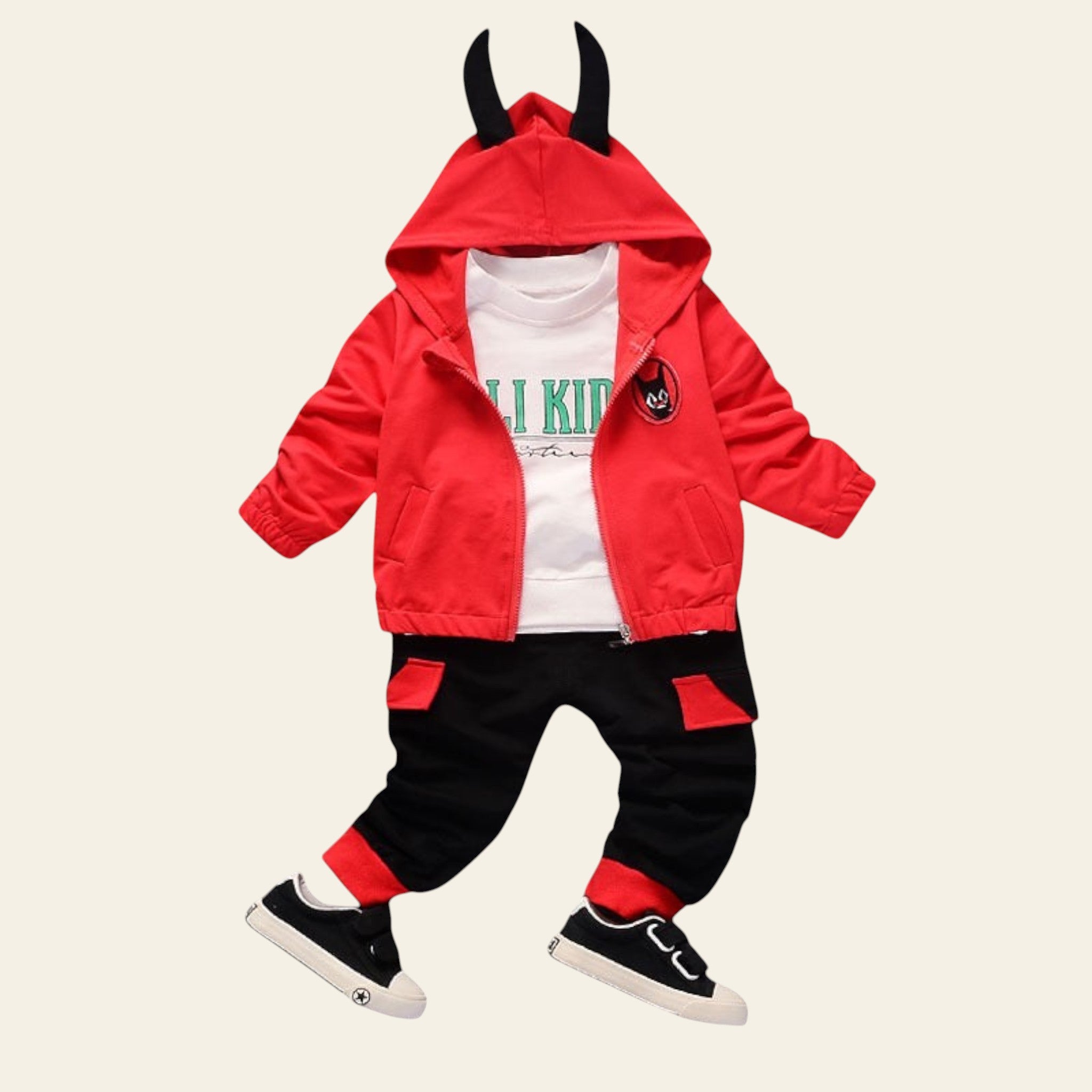 Children's outfit with red jacket, black pants, and white shoes on a gray background