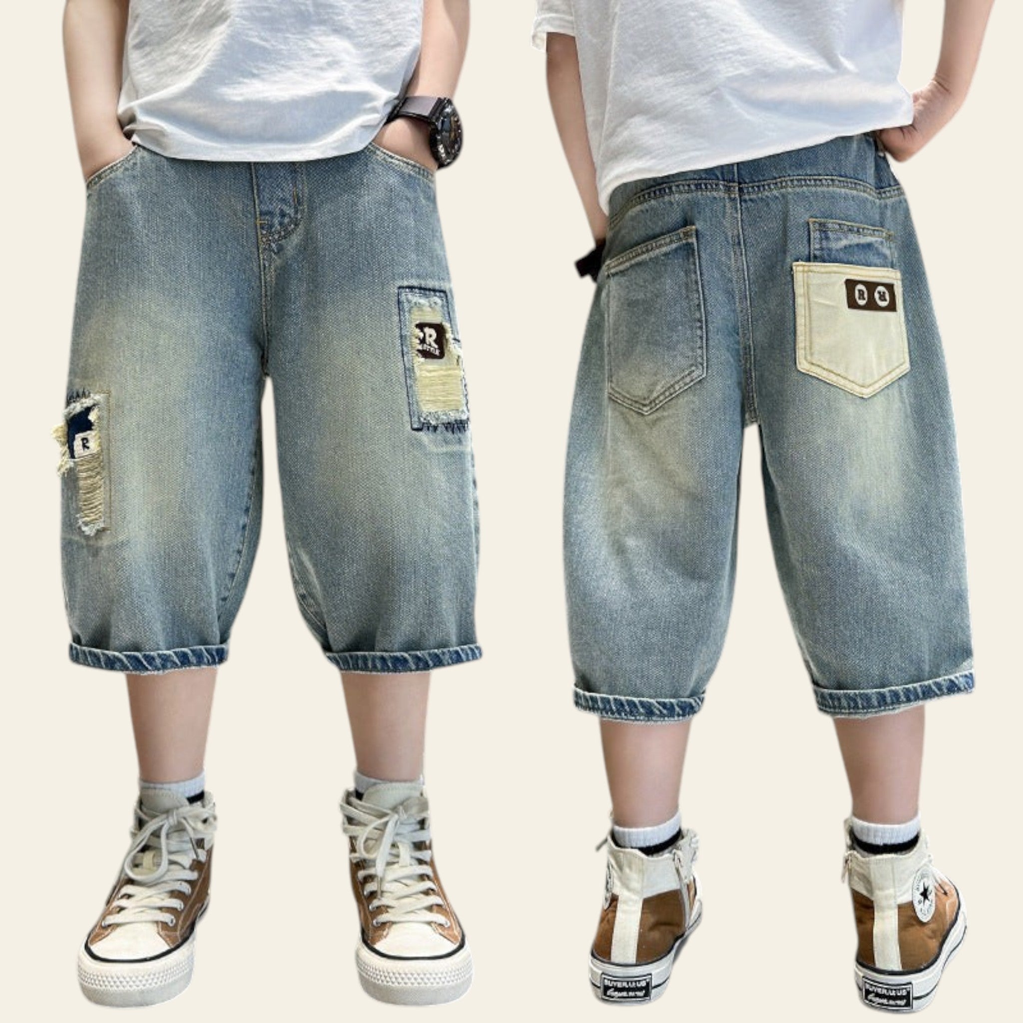 Two pairs of blue denim shorts with patchwork design on a metallic surface.