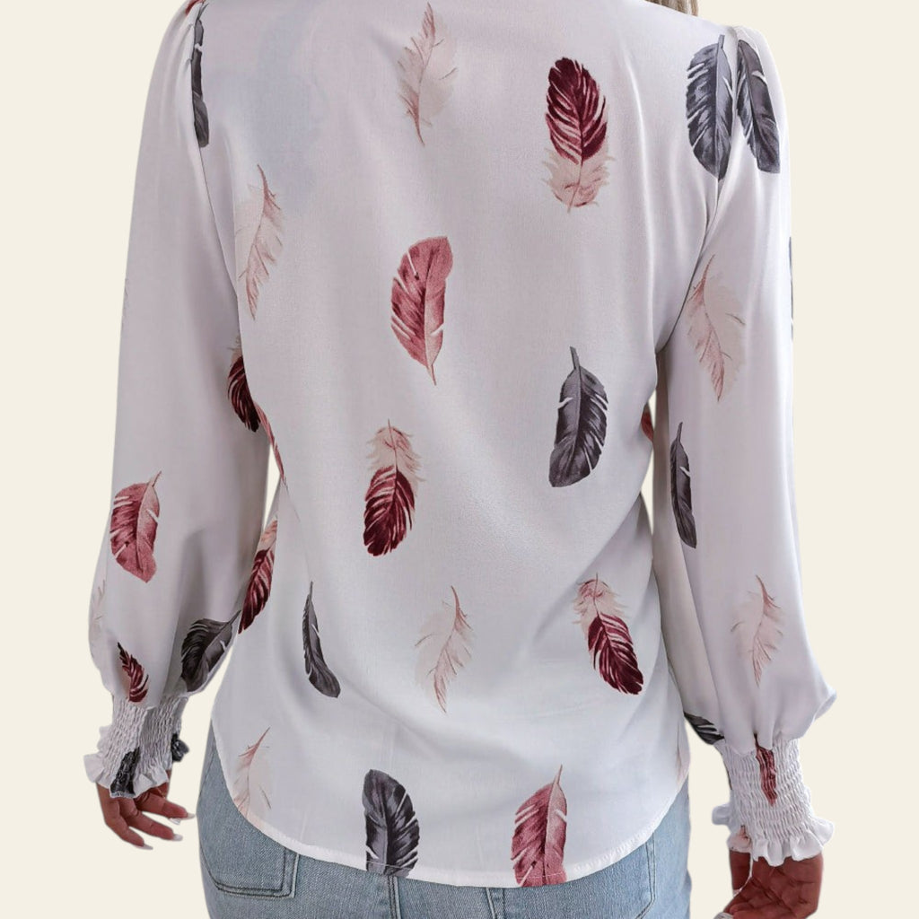Woman wearing a white blouse with feather pattern in a casual setting