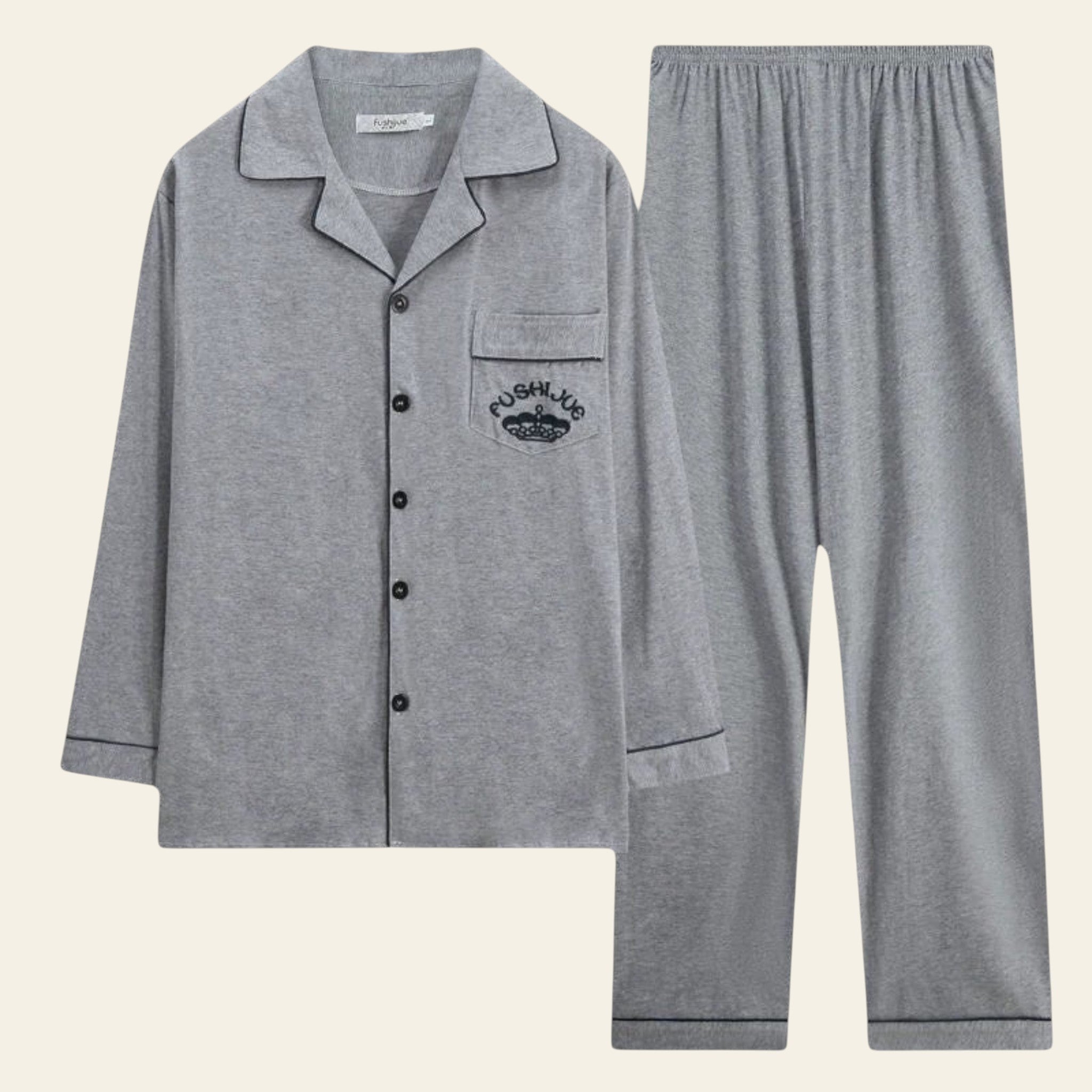 Gray pajama set with a logo on the chest pocket against a white background