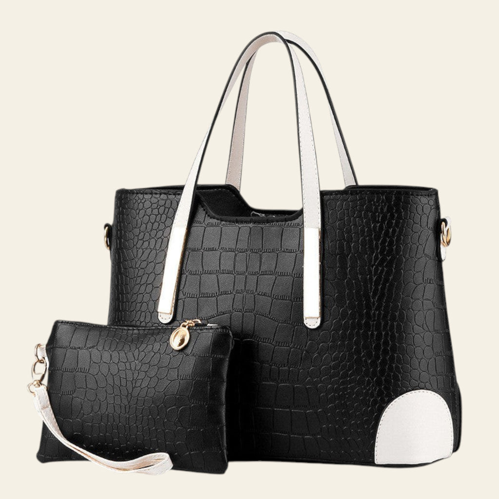 Black crocodile-patterned handbag with white accents and a matching pouch on a white background