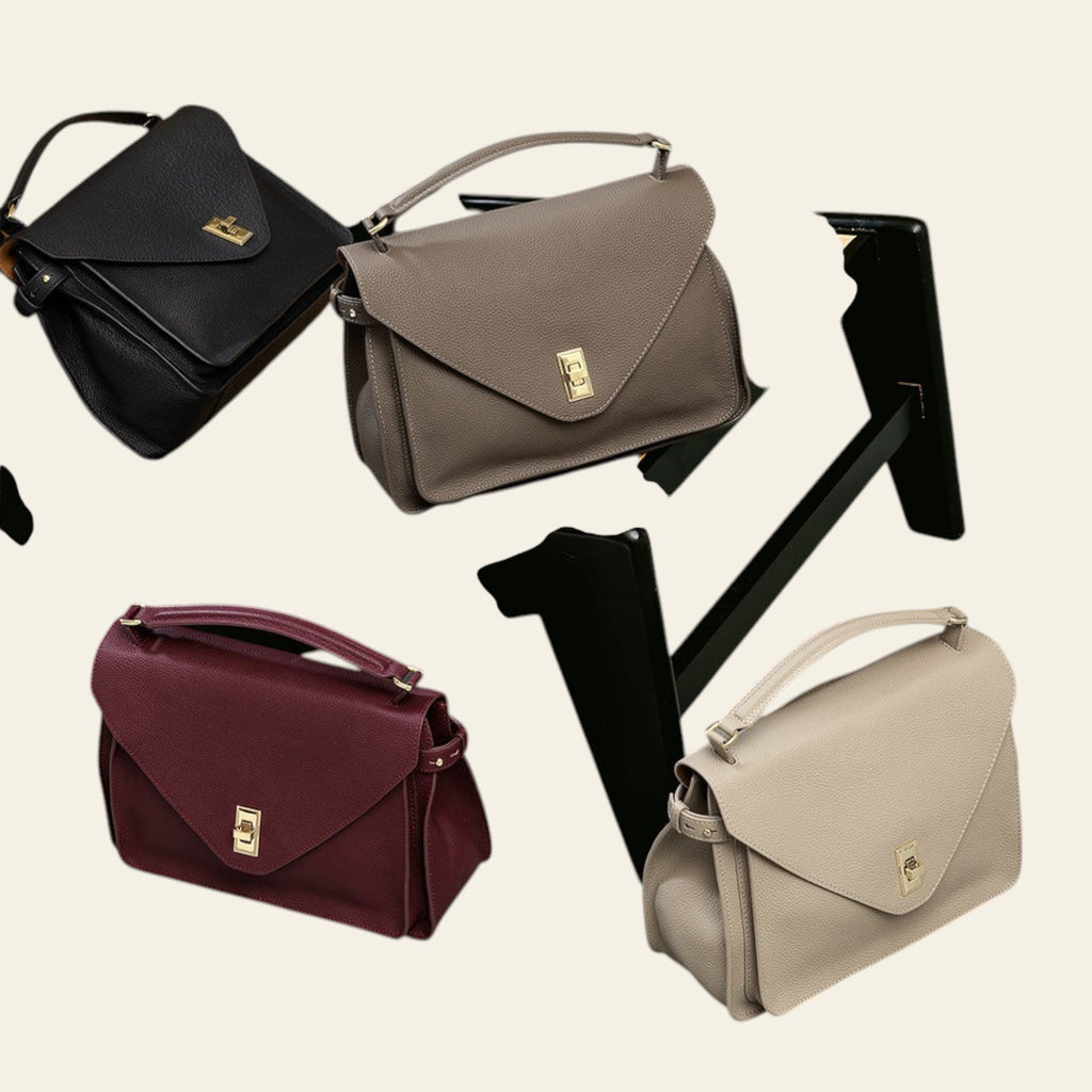 Four handbags in black, brown, red, and beige on a chair and surface.