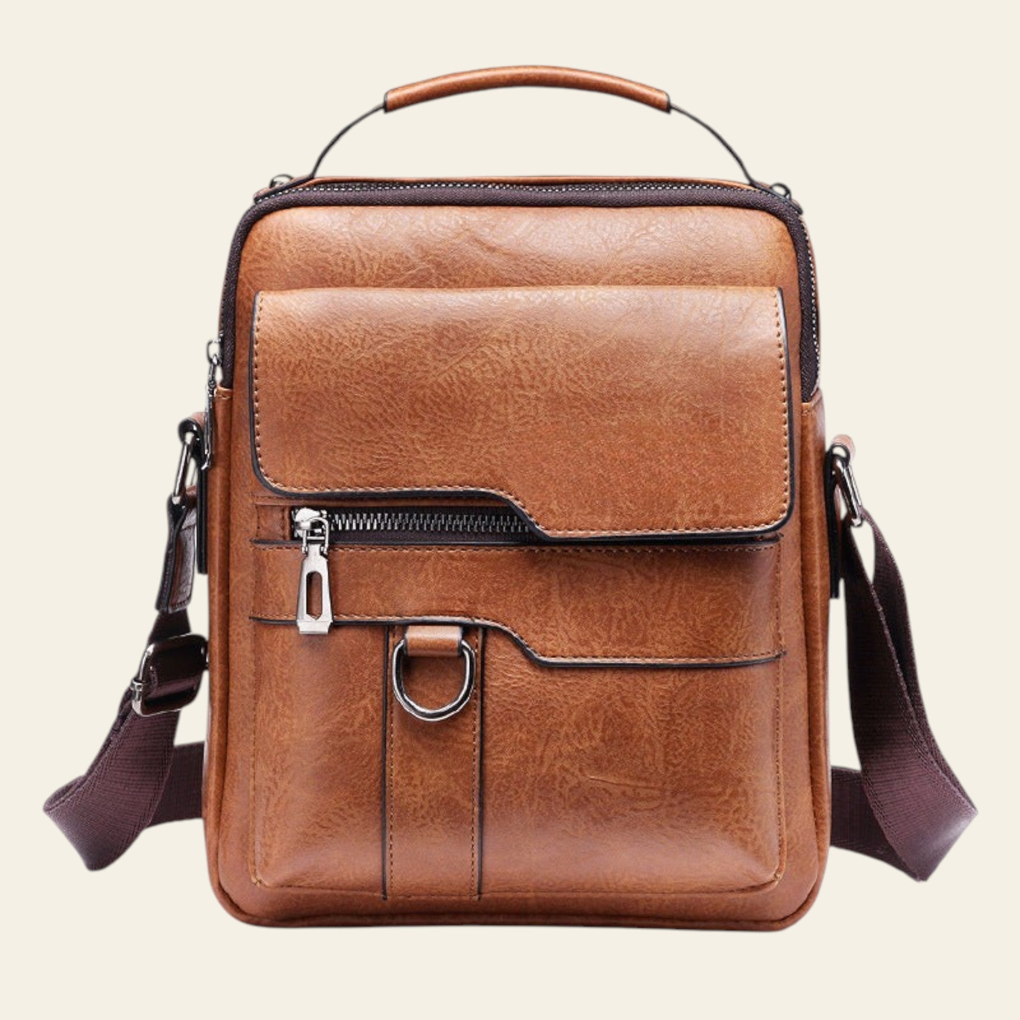 Brown leather crossbody bag with a strap on a white background
