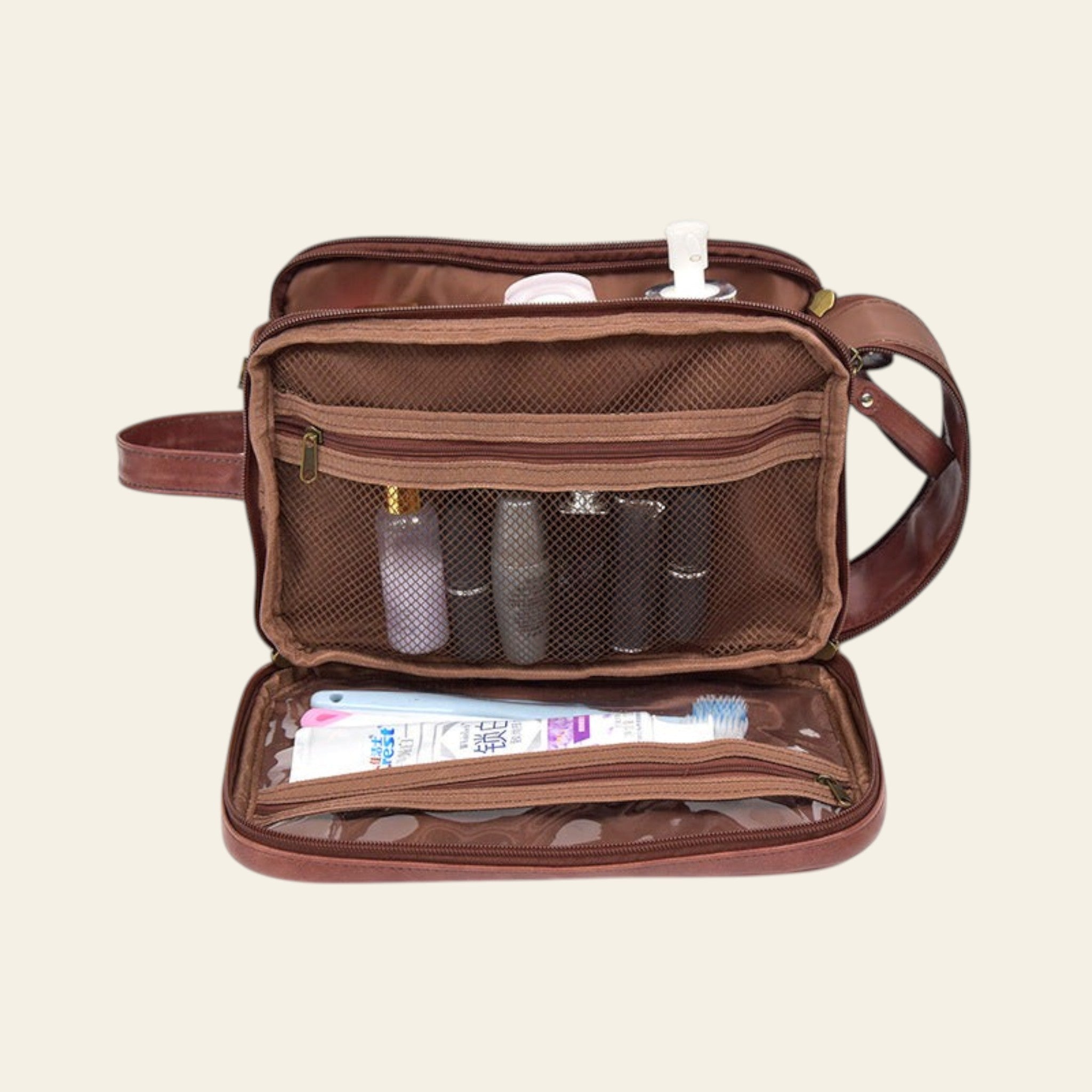 Brown toiletry bag with various items on a white background