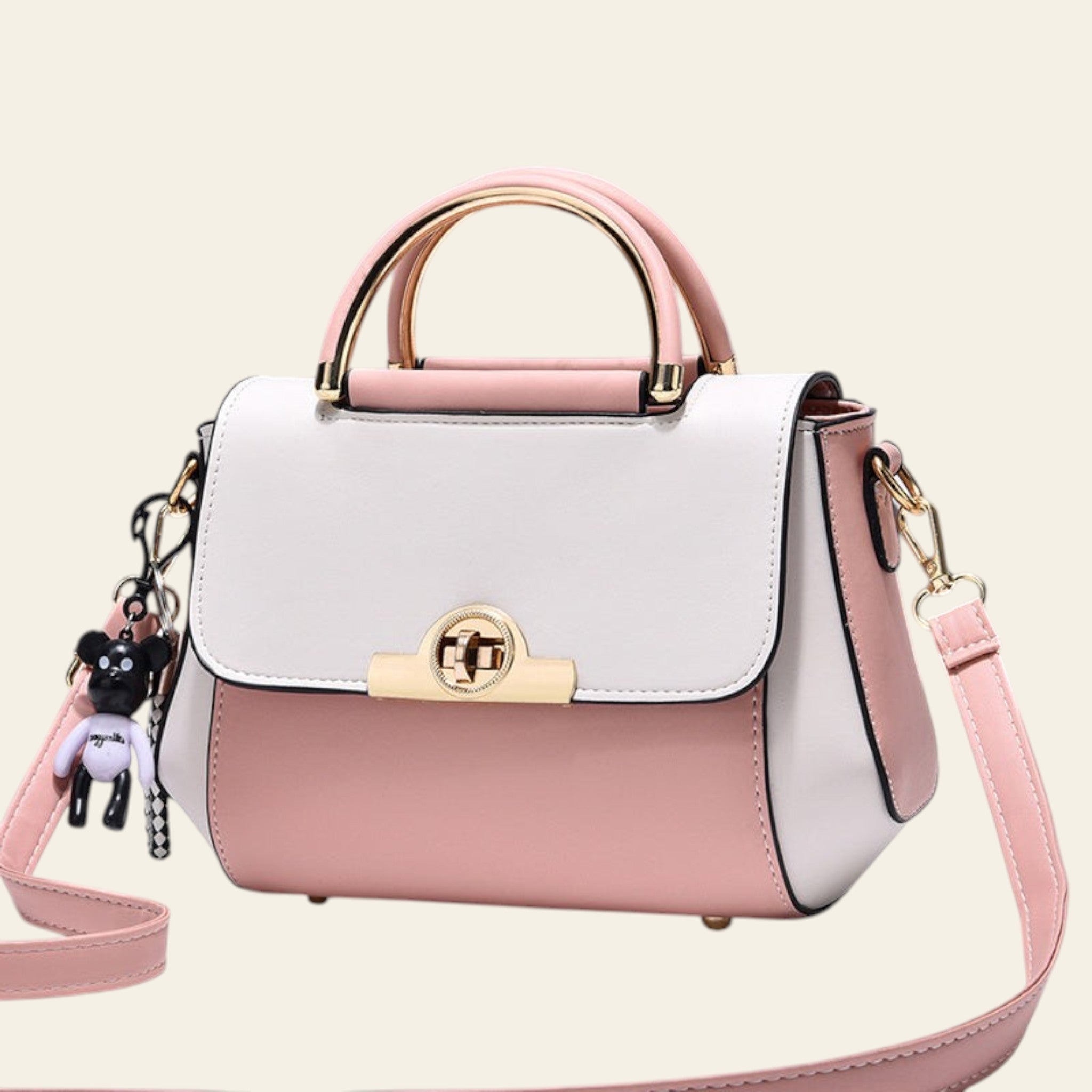 White and pink handbag with gold accents on a light gray background
