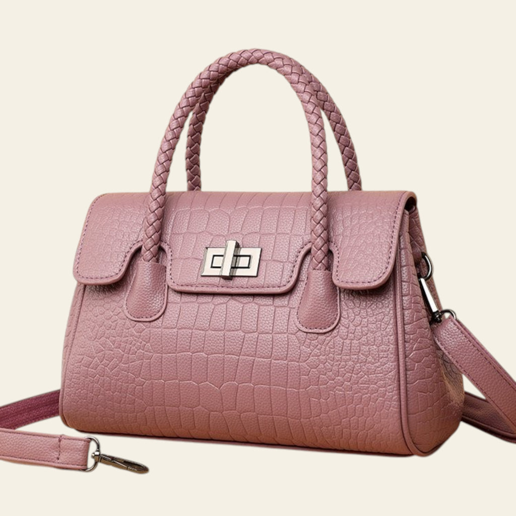 Pink handbag with a textured pattern on a beige background