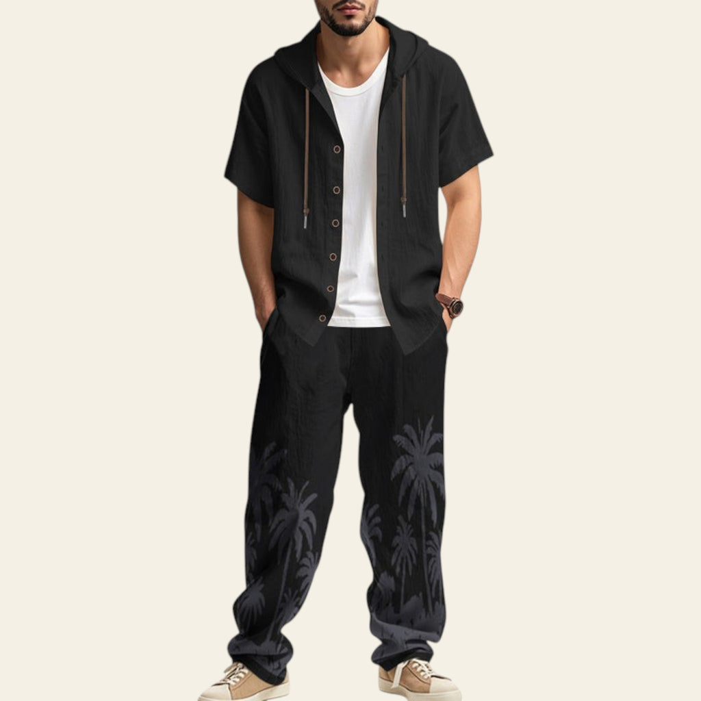Man wearing a complete men's casual set with hooded short sleeve shirt and matching trousers in black color