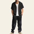 Man wearing a complete men's casual set with hooded short sleeve shirt and matching trousers in black color