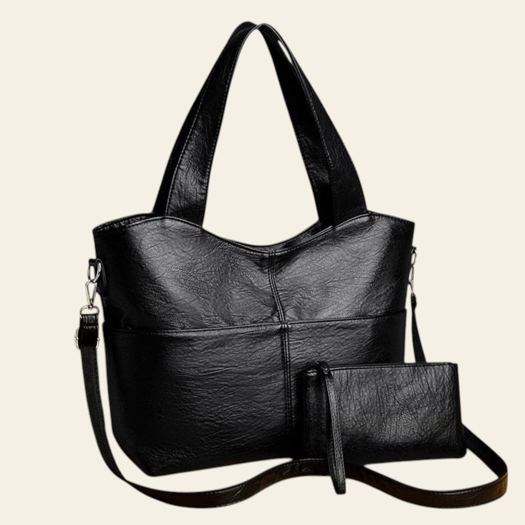 Black handbag with a matching pouch on a beige background