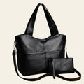 Black handbag with a matching pouch on a beige background