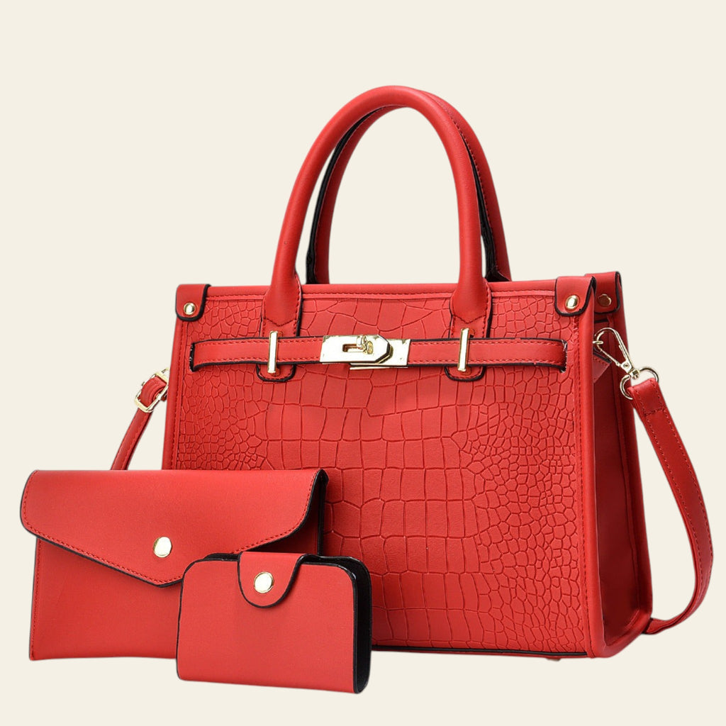 Red handbag and matching wallet with a white flower in the background