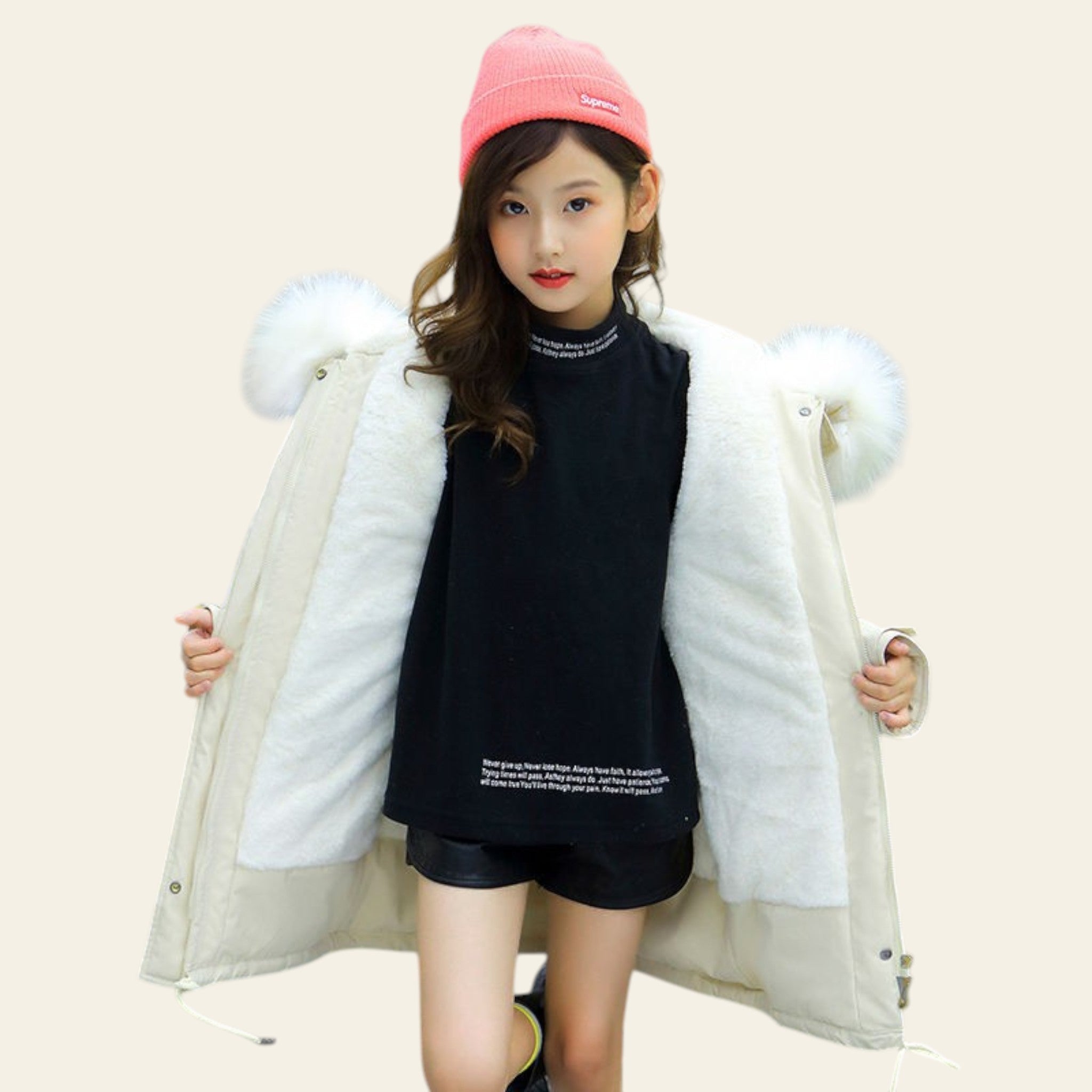 Person wearing a white fur-lined coat and pink beanie on a street.