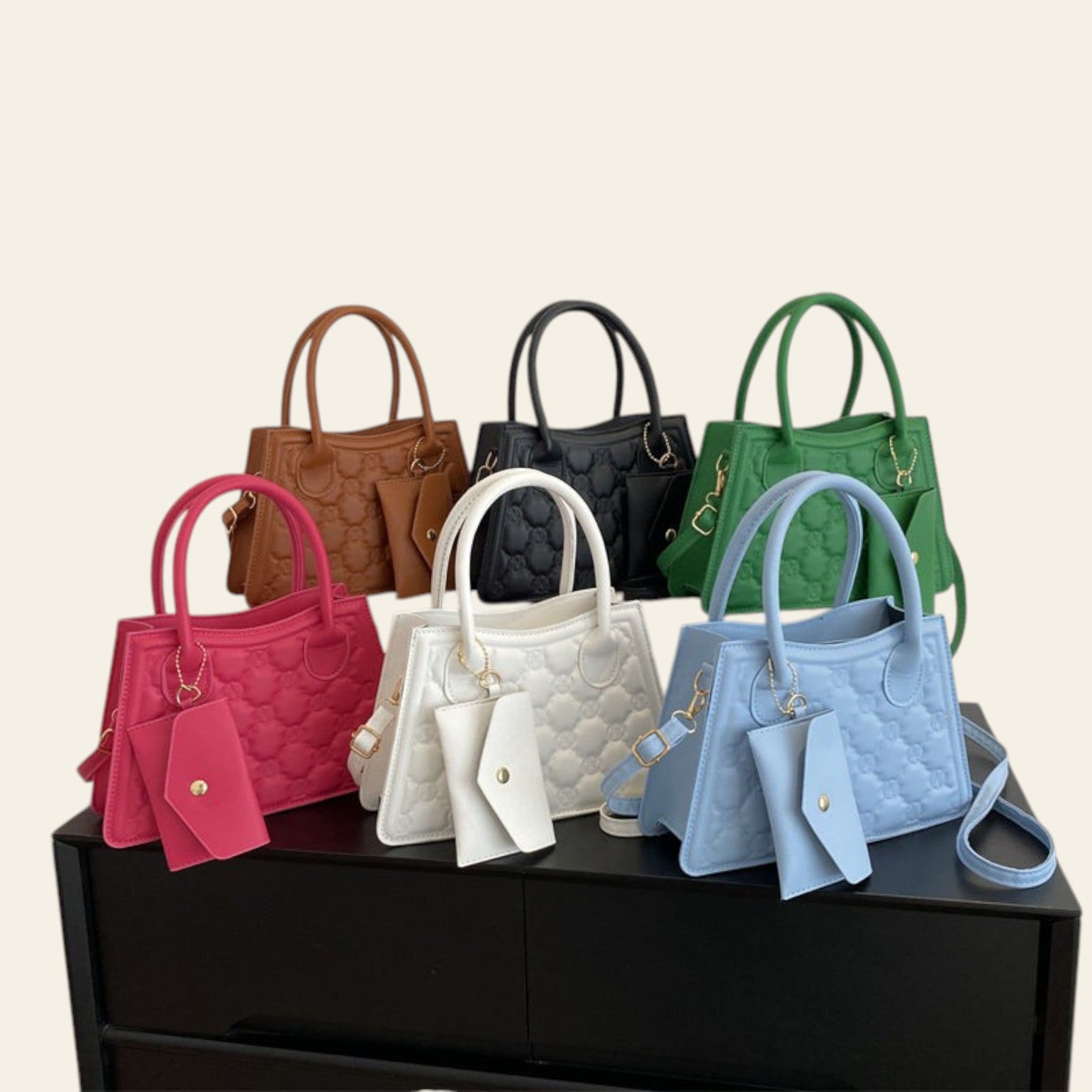 Collection of colorful handbags on a black surface with a white background
