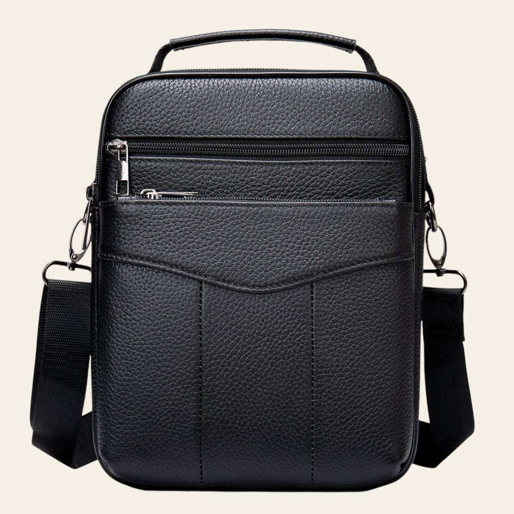 Black leather crossbody bag with multiple pockets on a white background