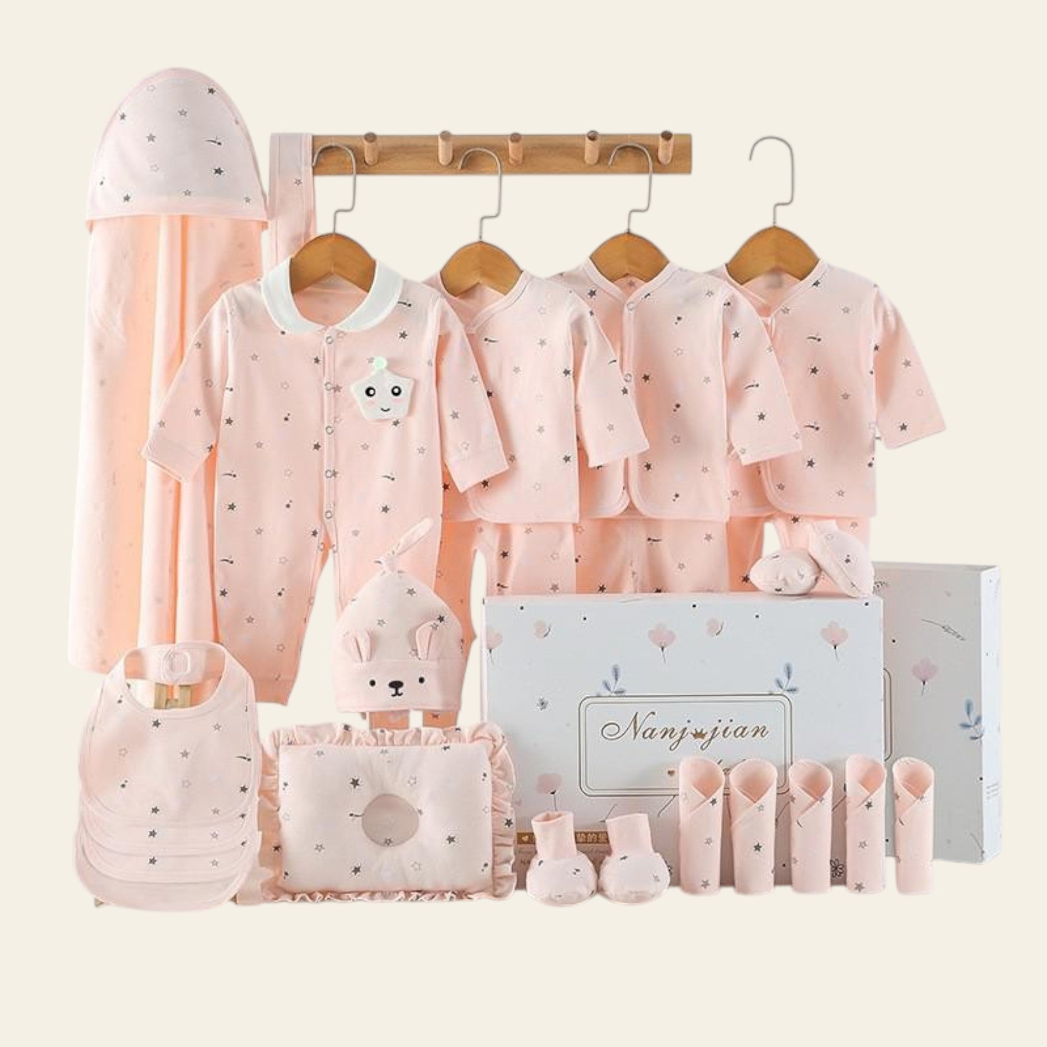 Baby clothing set with pink outfits, hats, and accessories on a white background